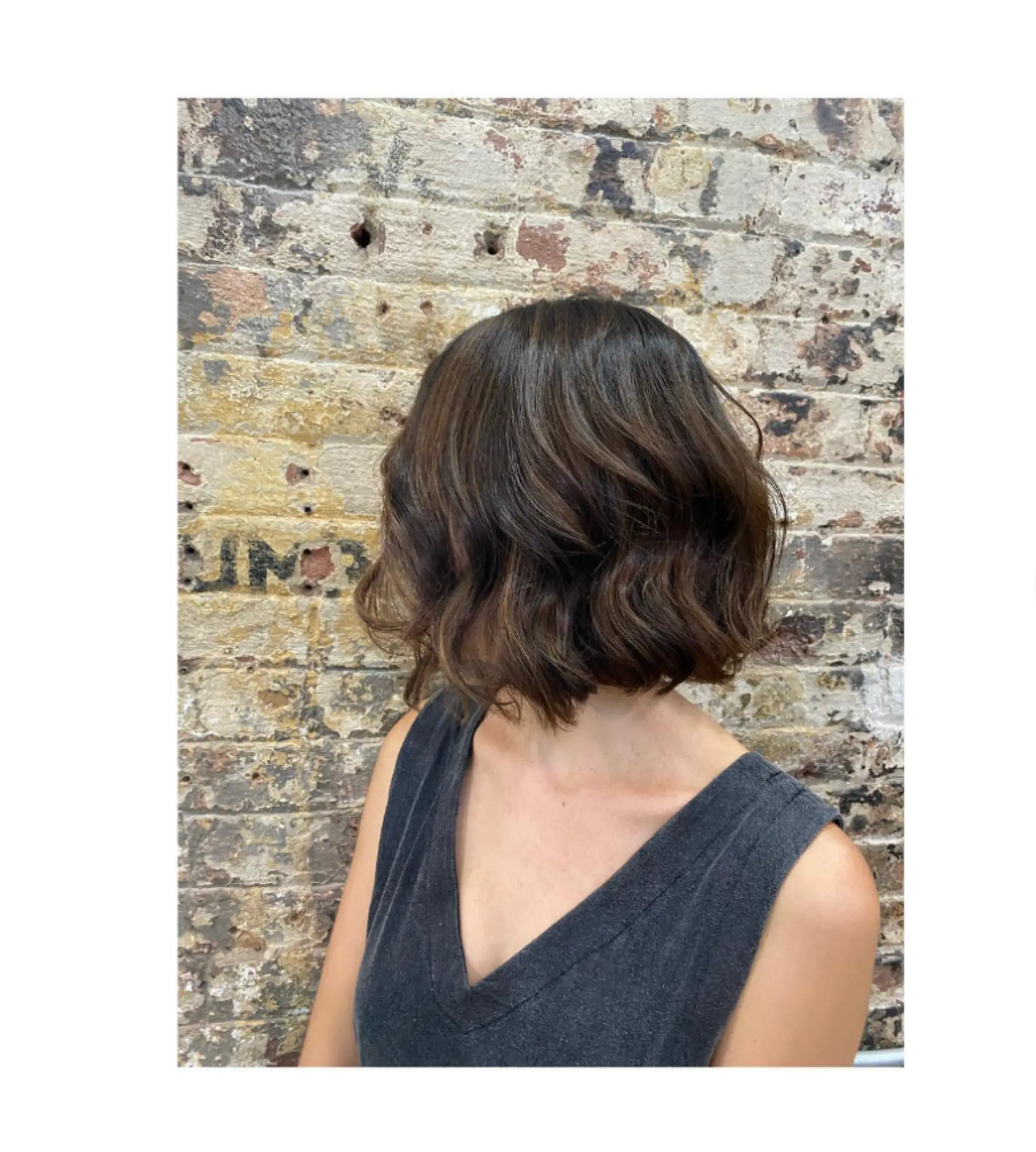 A short, wavy bob with subtle highlights for added dimension. 1