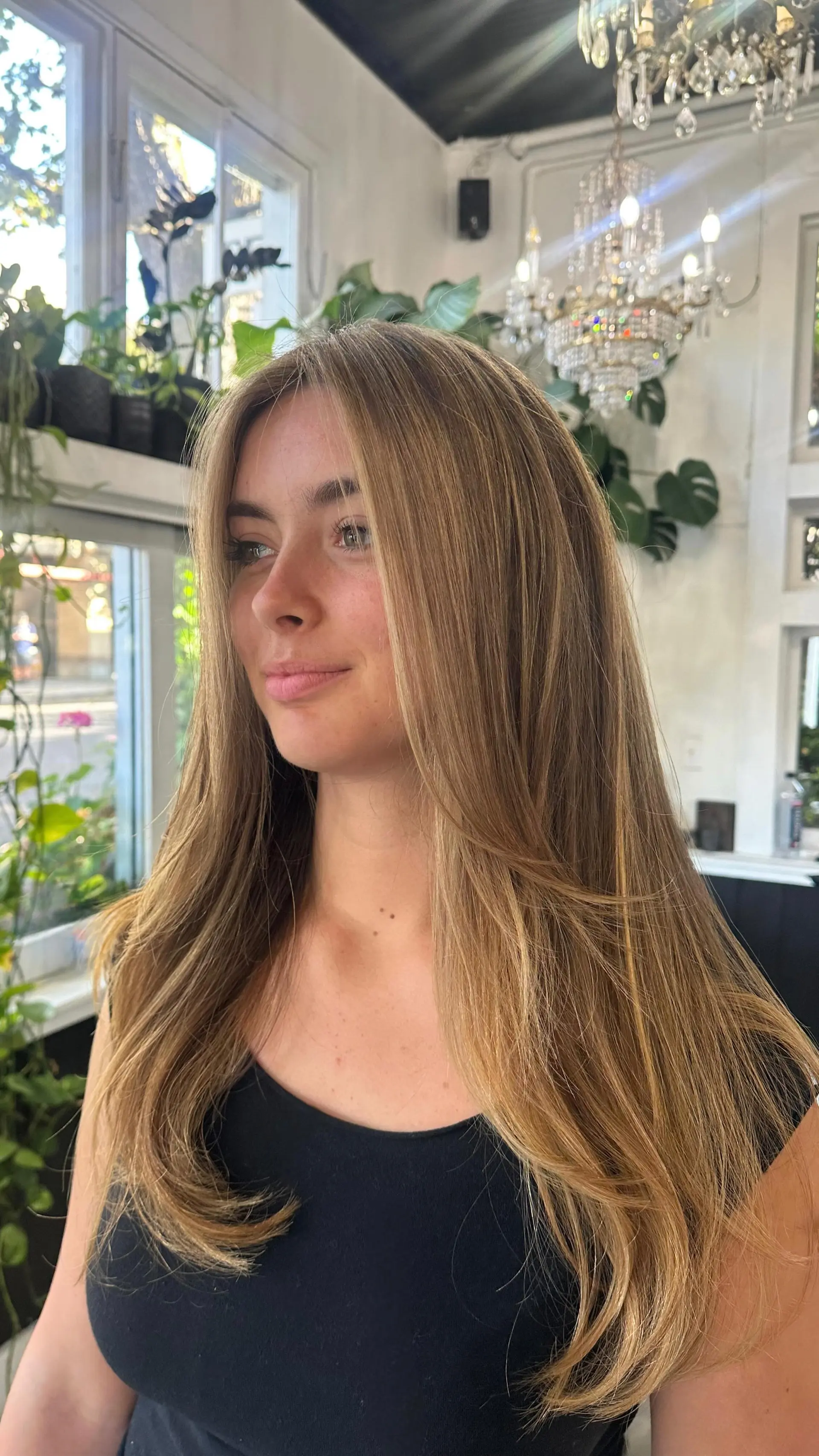 Long honey-caramel blonde hair with face-framing layers and soft curved ends. 1