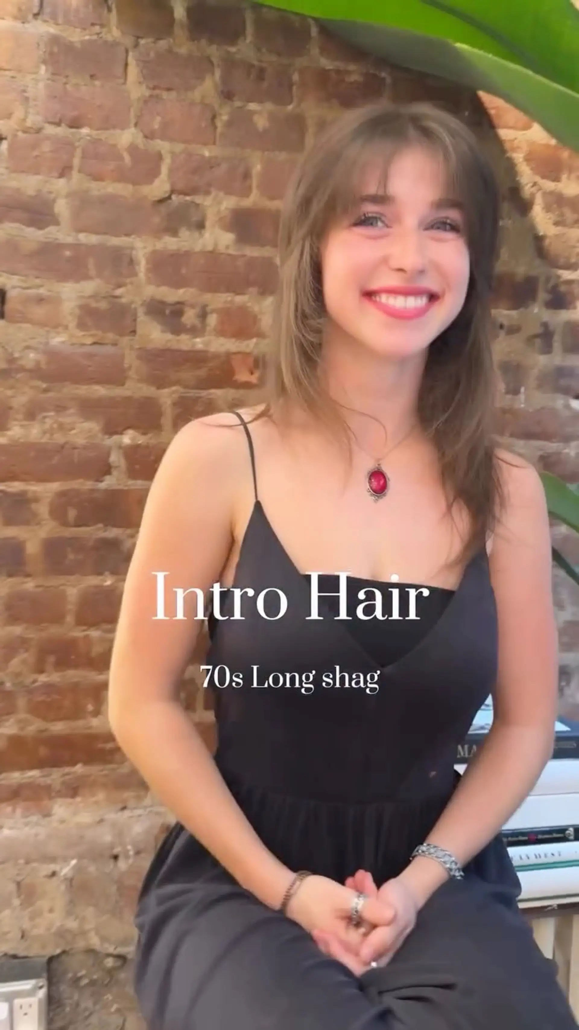 A retro 70s-style long shag haircut featuring face-framing feathered layers and wispy bangs. 1