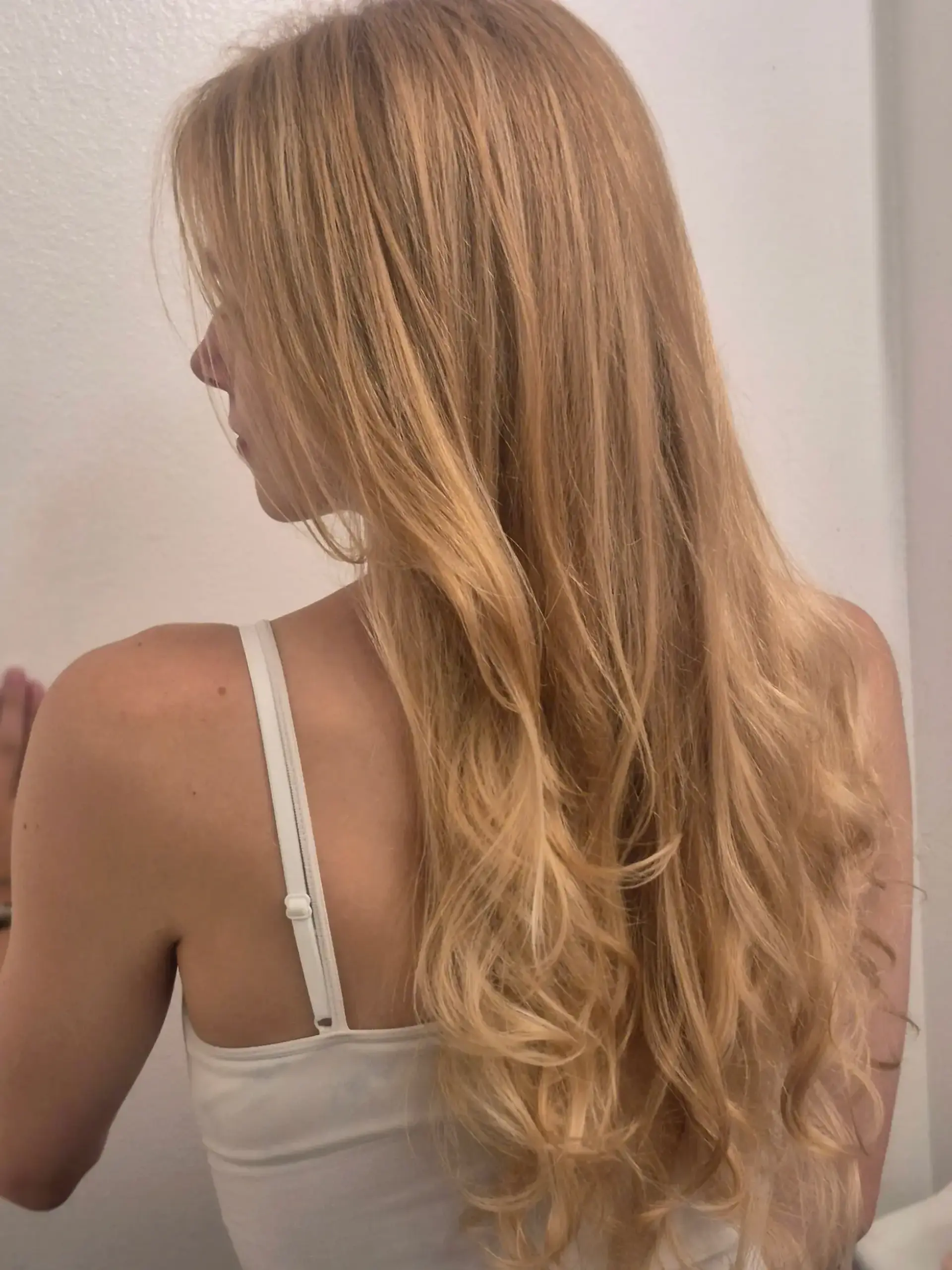 Extra-long warm golden blonde hair styled smoothly from the roots with soft, voluminous waves at the ends. 1