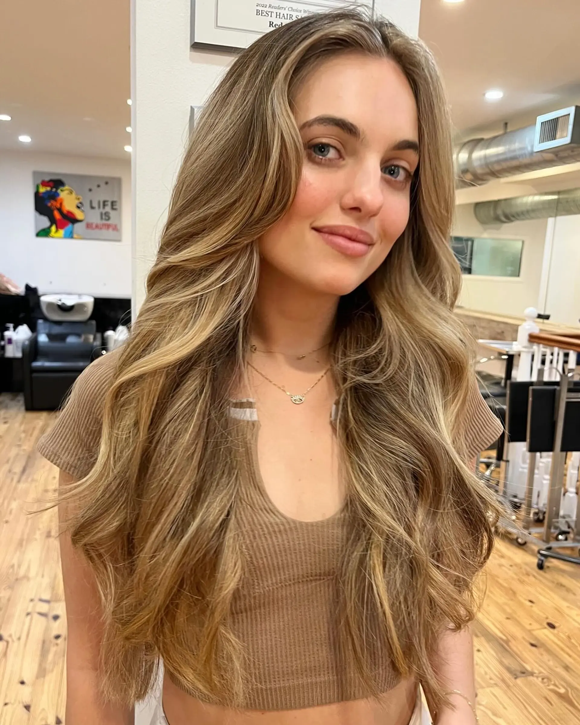 Long, wavy hair with face-framing layers and a beachy balayage. 1