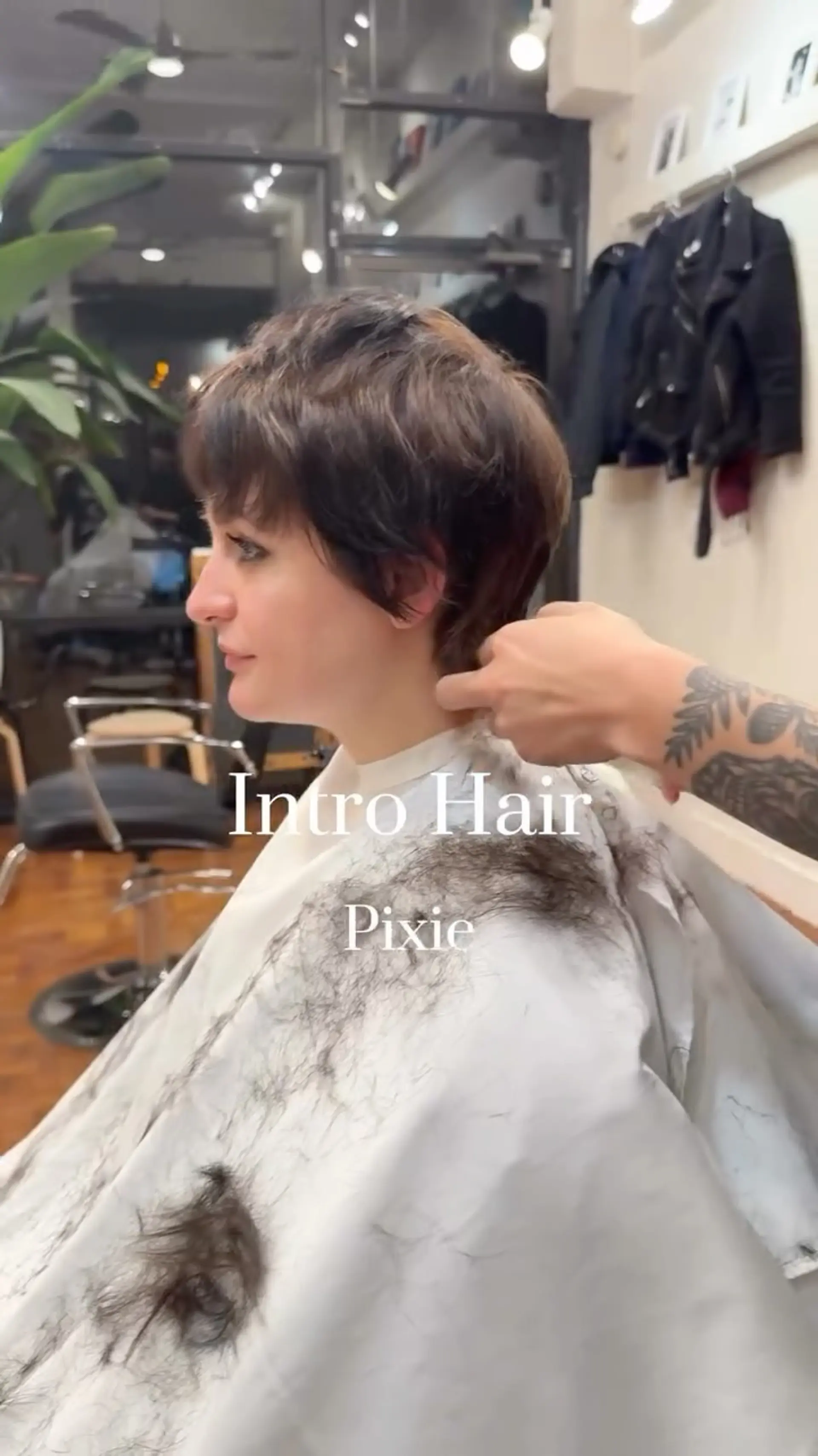 A textured brunette pixie cut with soft, layered bangs and wispy neck-length styling. 1