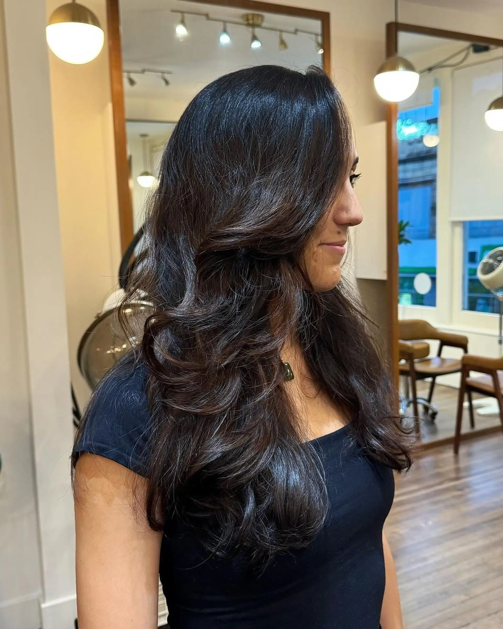 Long dark brown wavy hair with a side part, featuring natural shine and elegant layers. 1