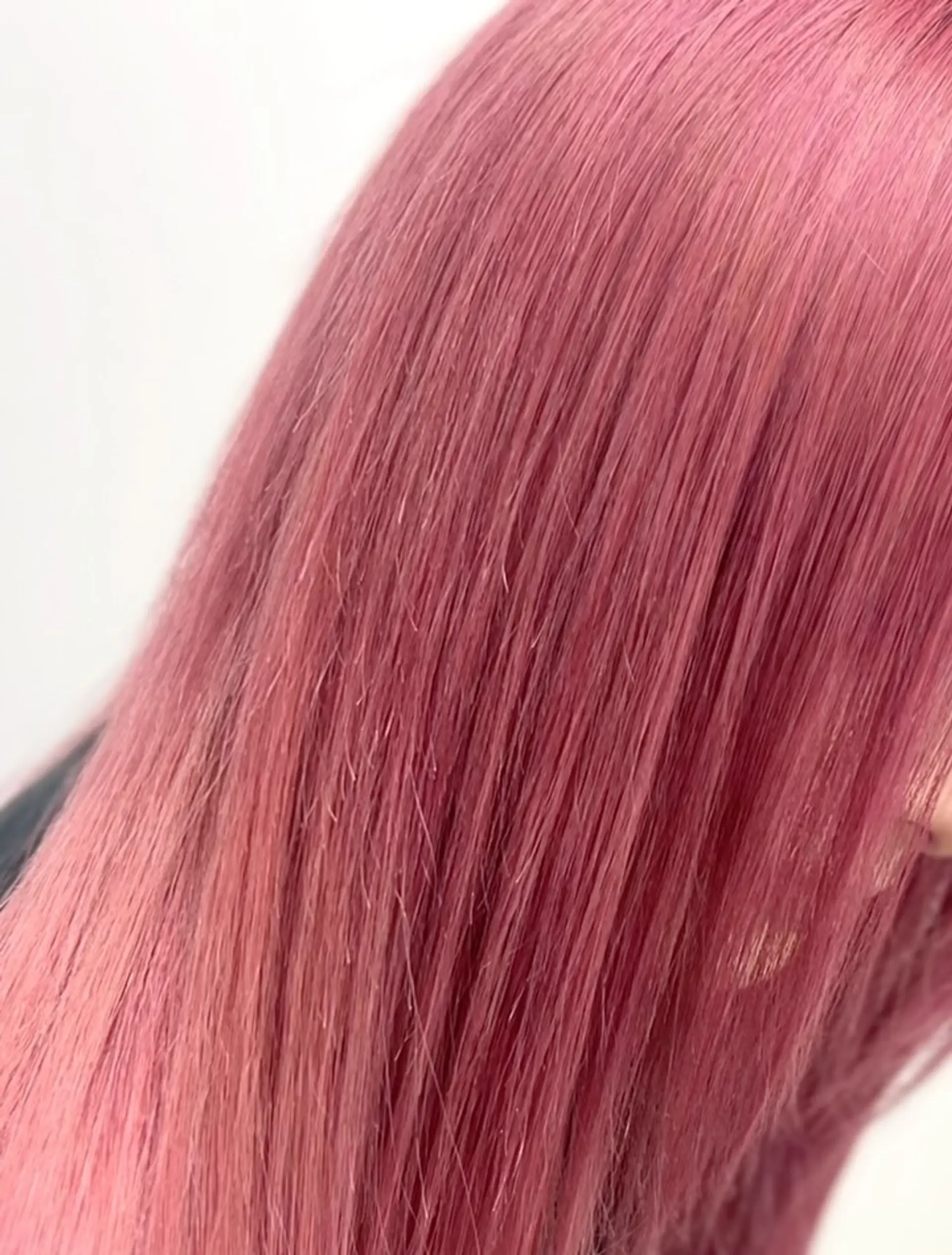 Straight, sleek hair finished in a rich and saturated dusty rose pink tone. 1