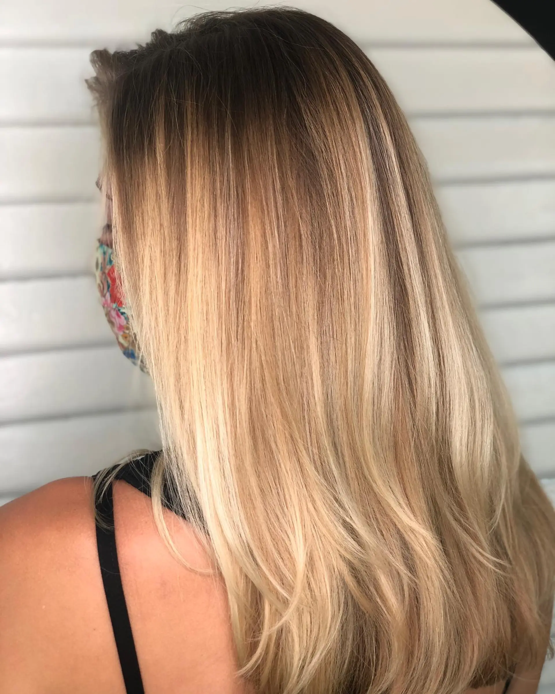 Long smooth golden blonde balayage with a soft root melt and layered ends. 1