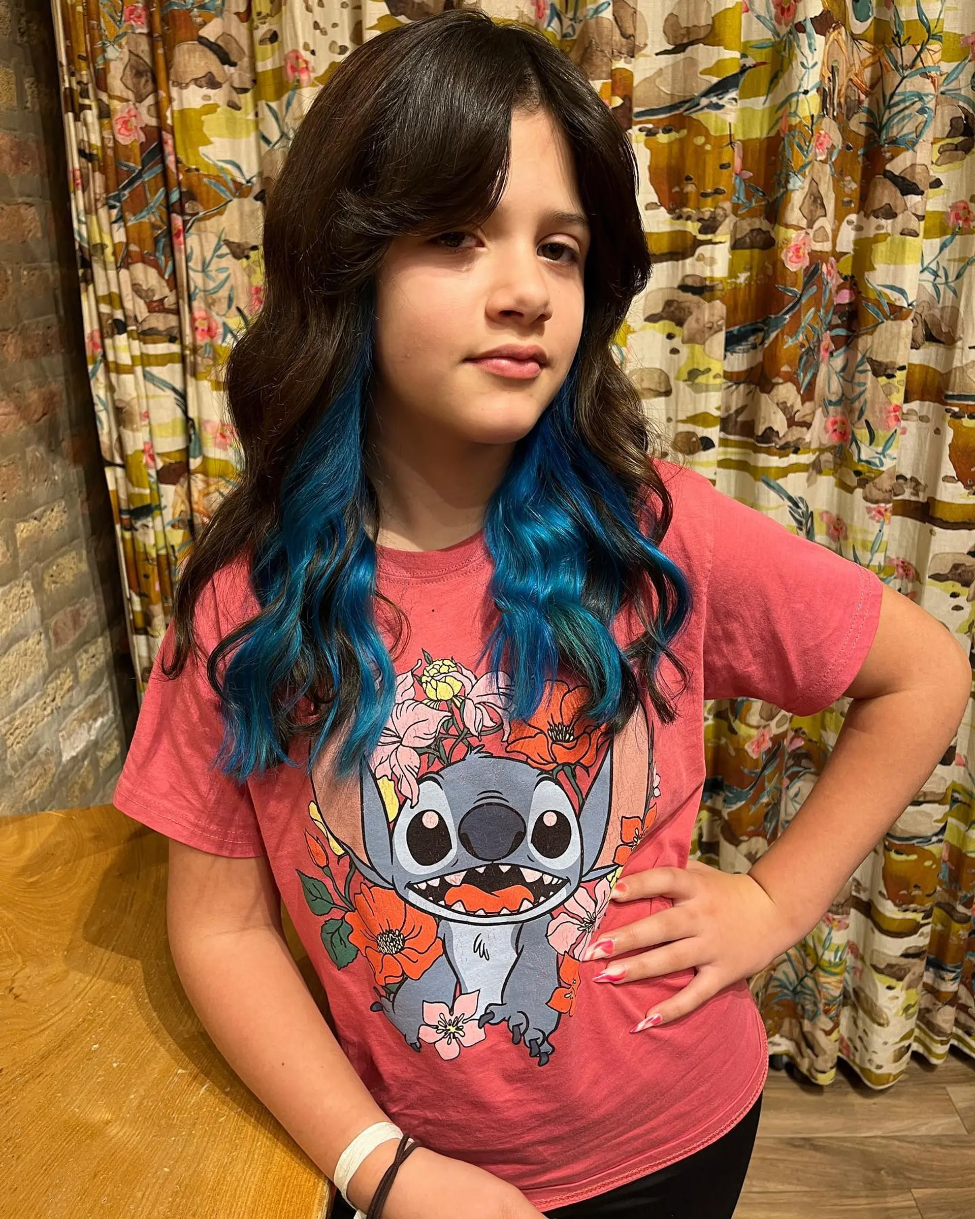 Trendy medium-length waves with face-framing layers and peekaboo blue highlights. 1