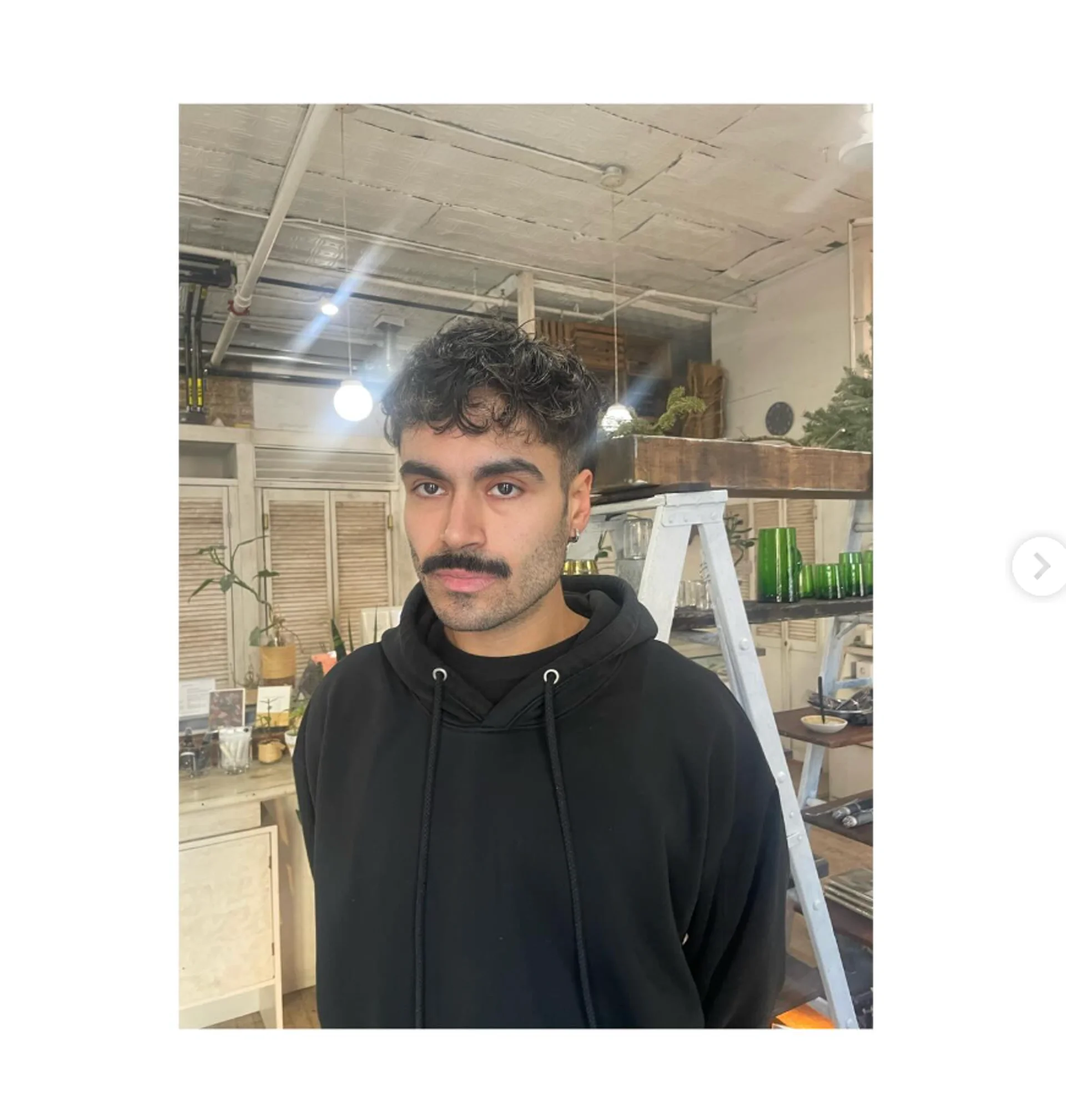 A man with a modern textured crop haircut with natural waves, showcasing a stylish and effortless look in a NYC salon. - Preview 3