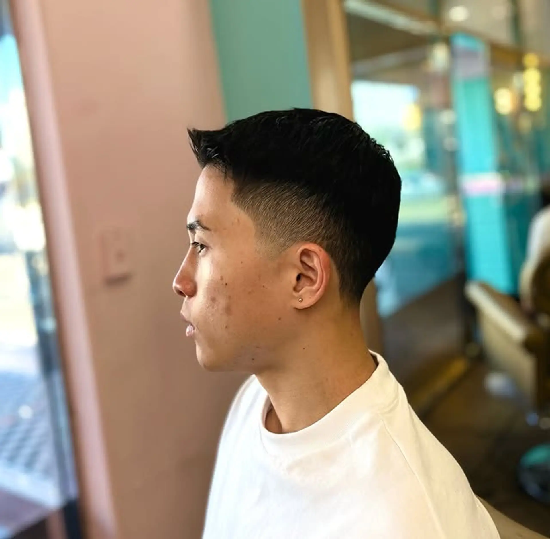 A short taper fade with clean lines and a modern edge. 1