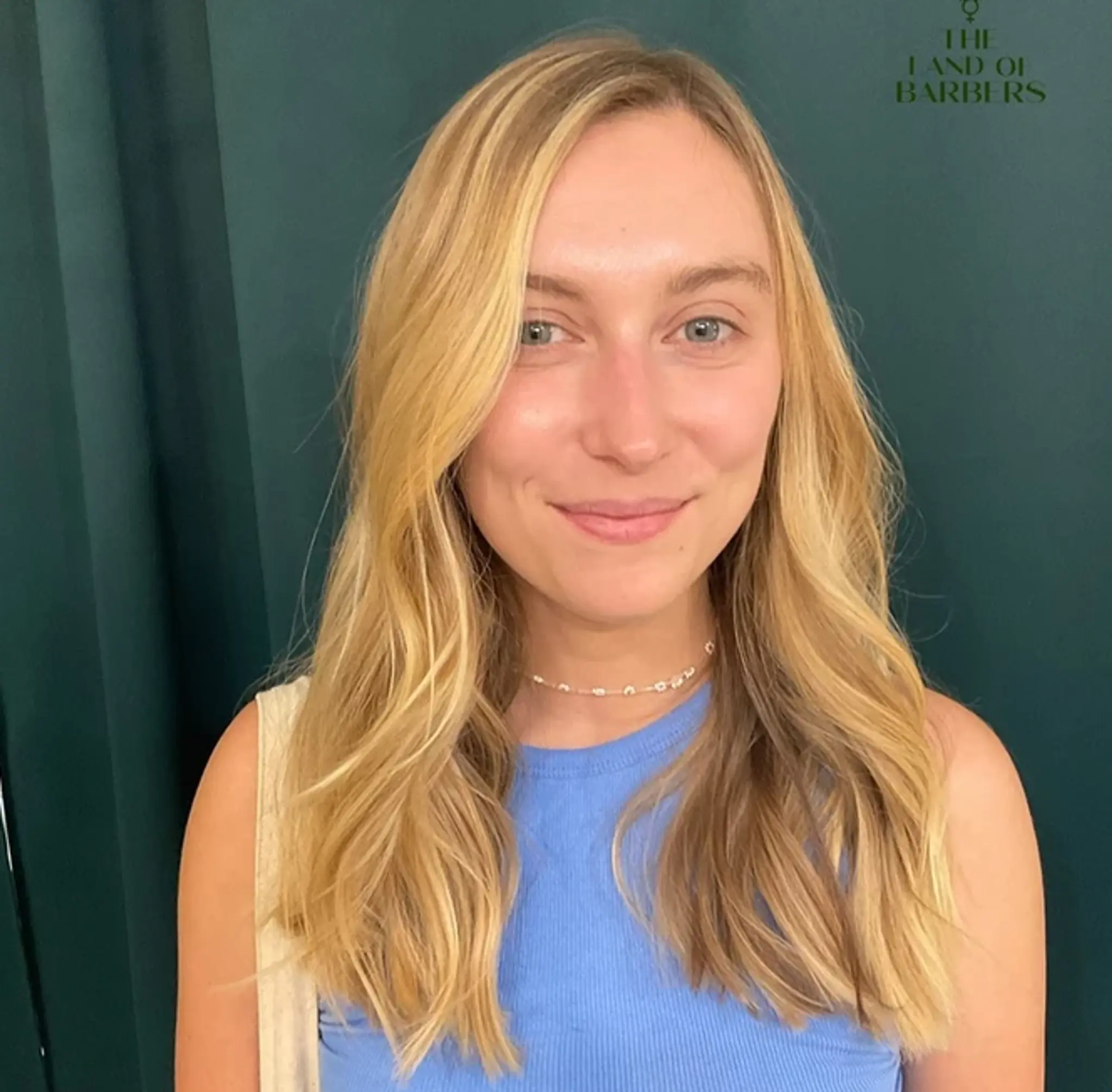 Long, wavy, and blonde with face-framing layers and a natural part, creating a sun-kissed, effortlessly elegant look.