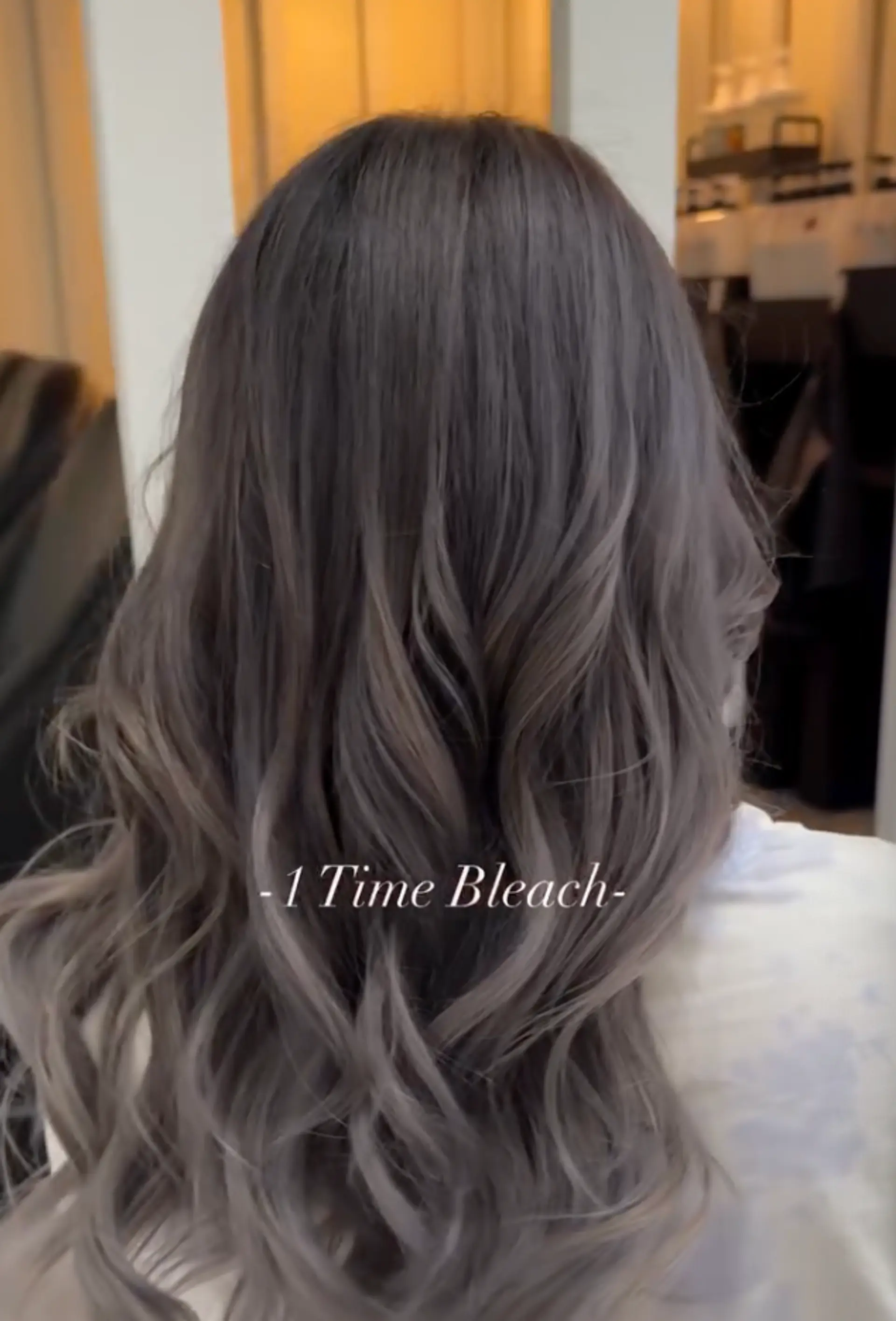 Long, wavy hair in ash gray and silver ombre with soft, loose curls and a layered cut.

Stylist: @yurihair.newyork 1