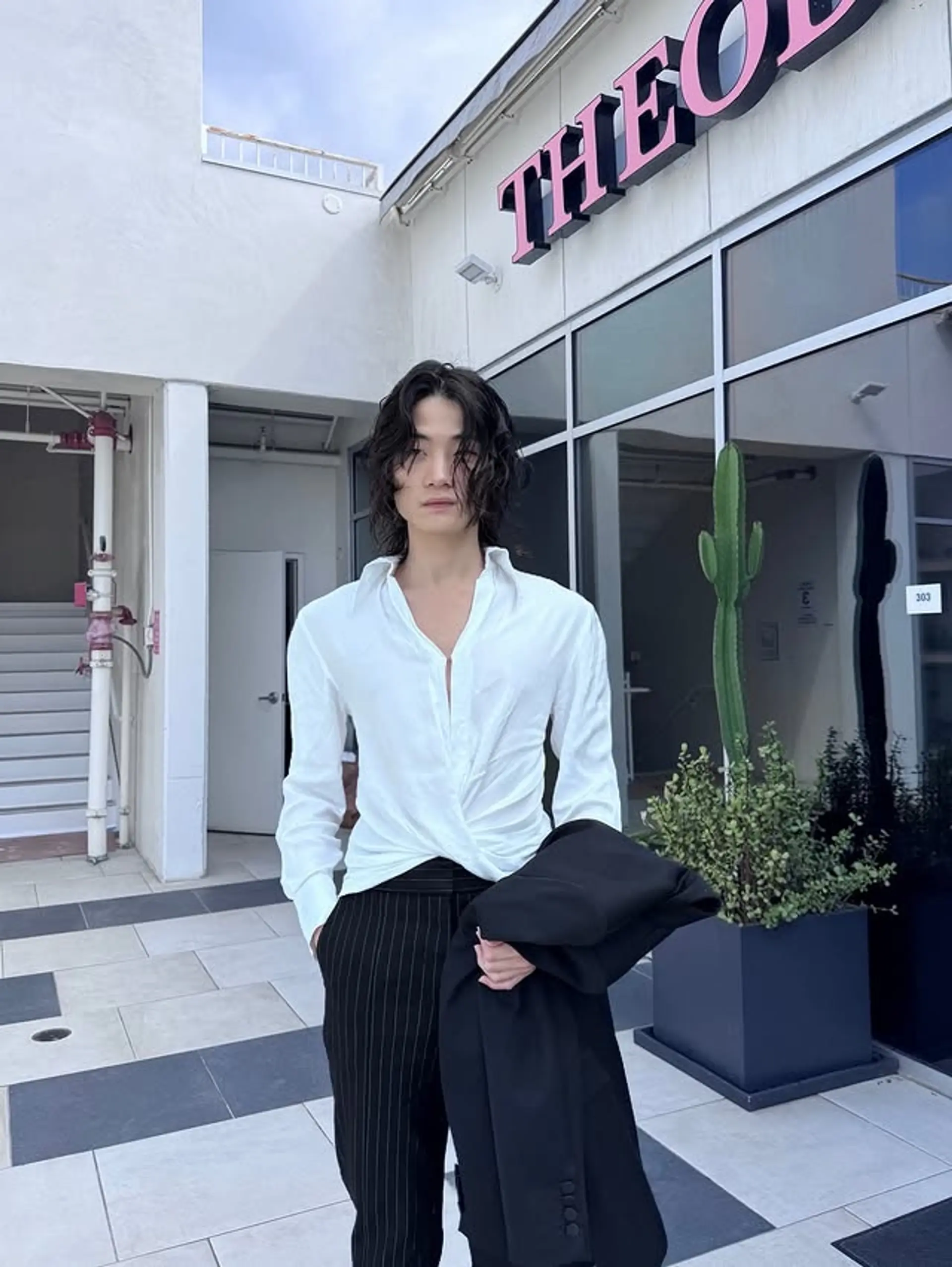 This hairstyle features medium-length, flowy, wavy hair with a middle part and textured ends. 1