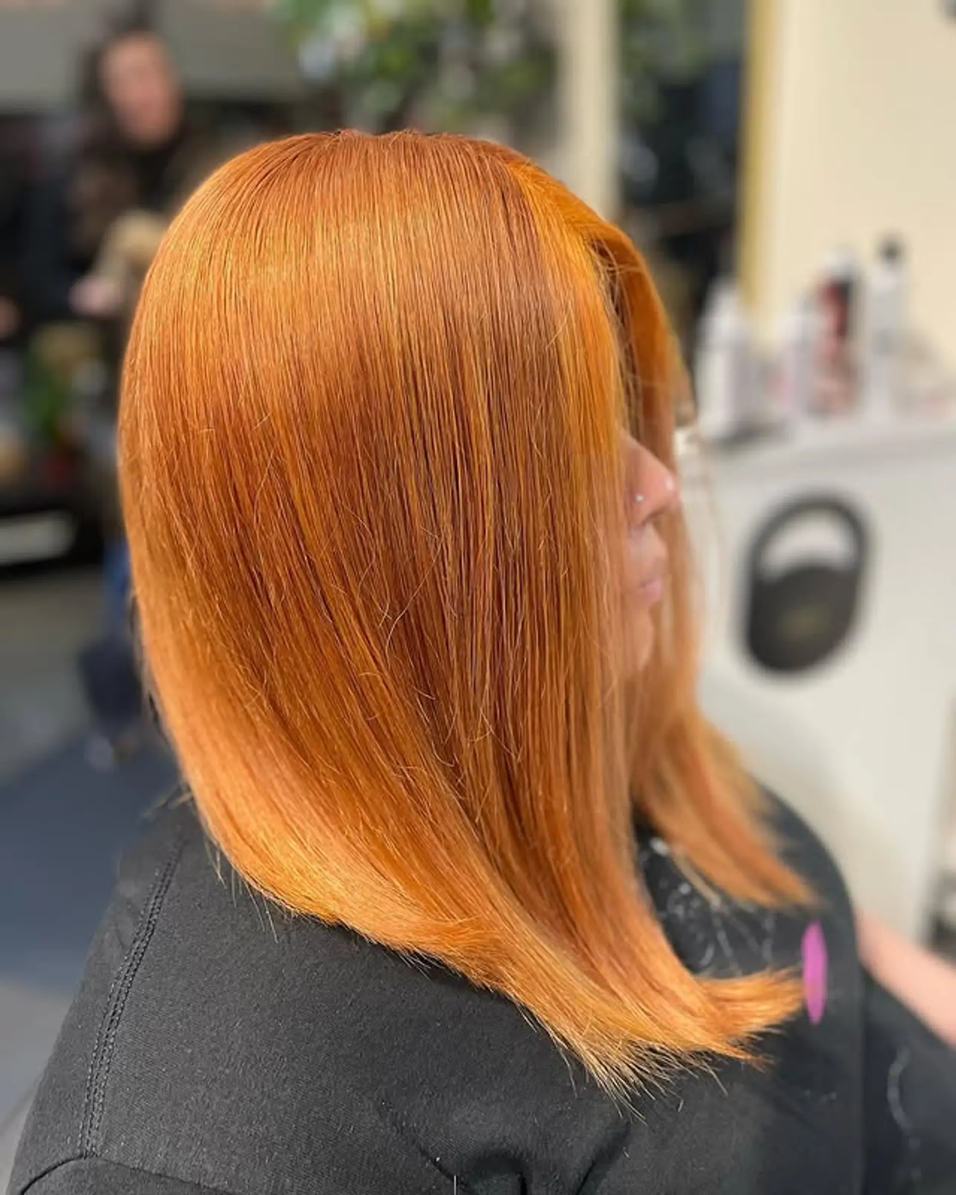 A sleek and shiny mid-length bob with a vibrant copper color. 1