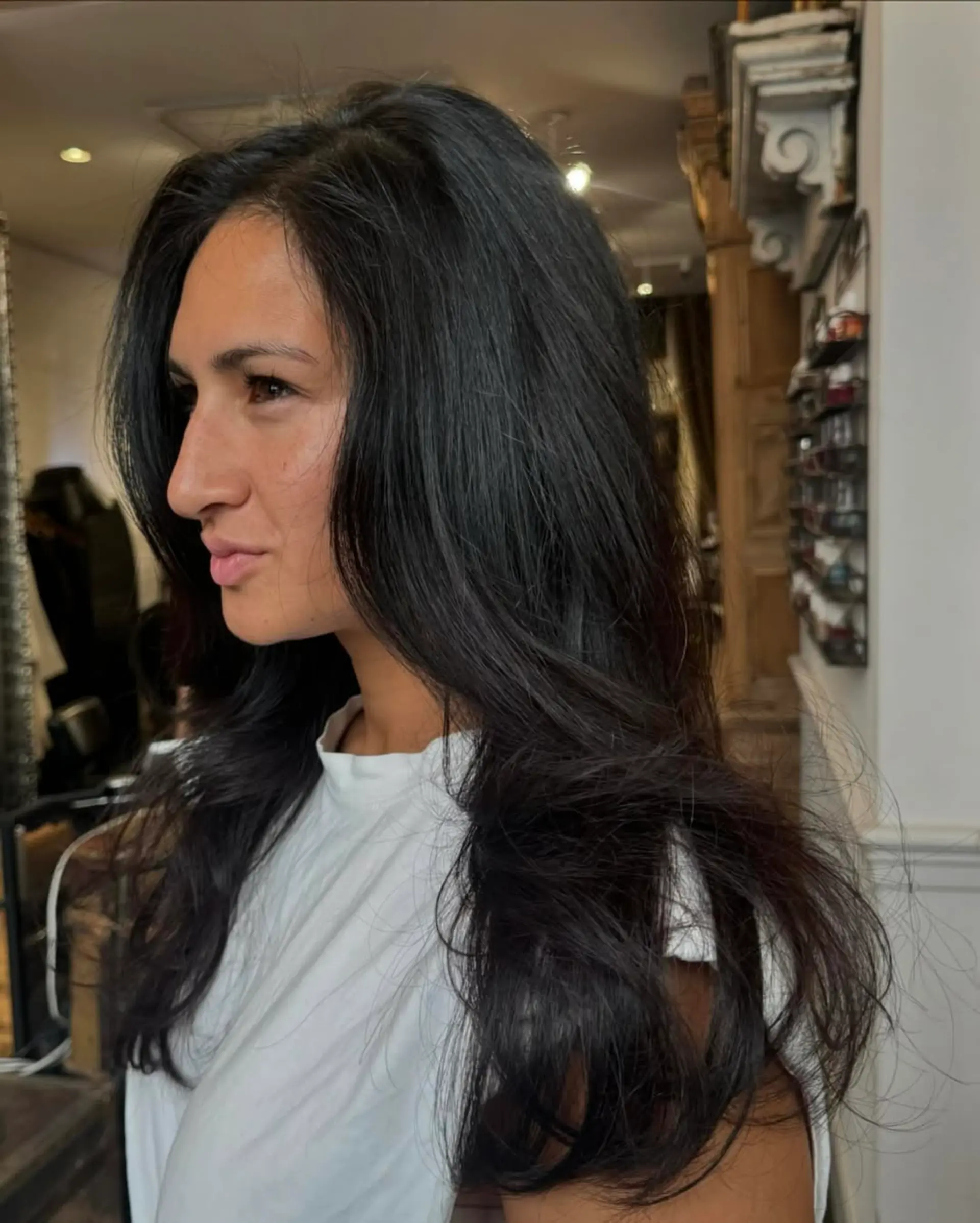 Long wavy hair with sleek layers and a side part, showcasing natural shine. 4