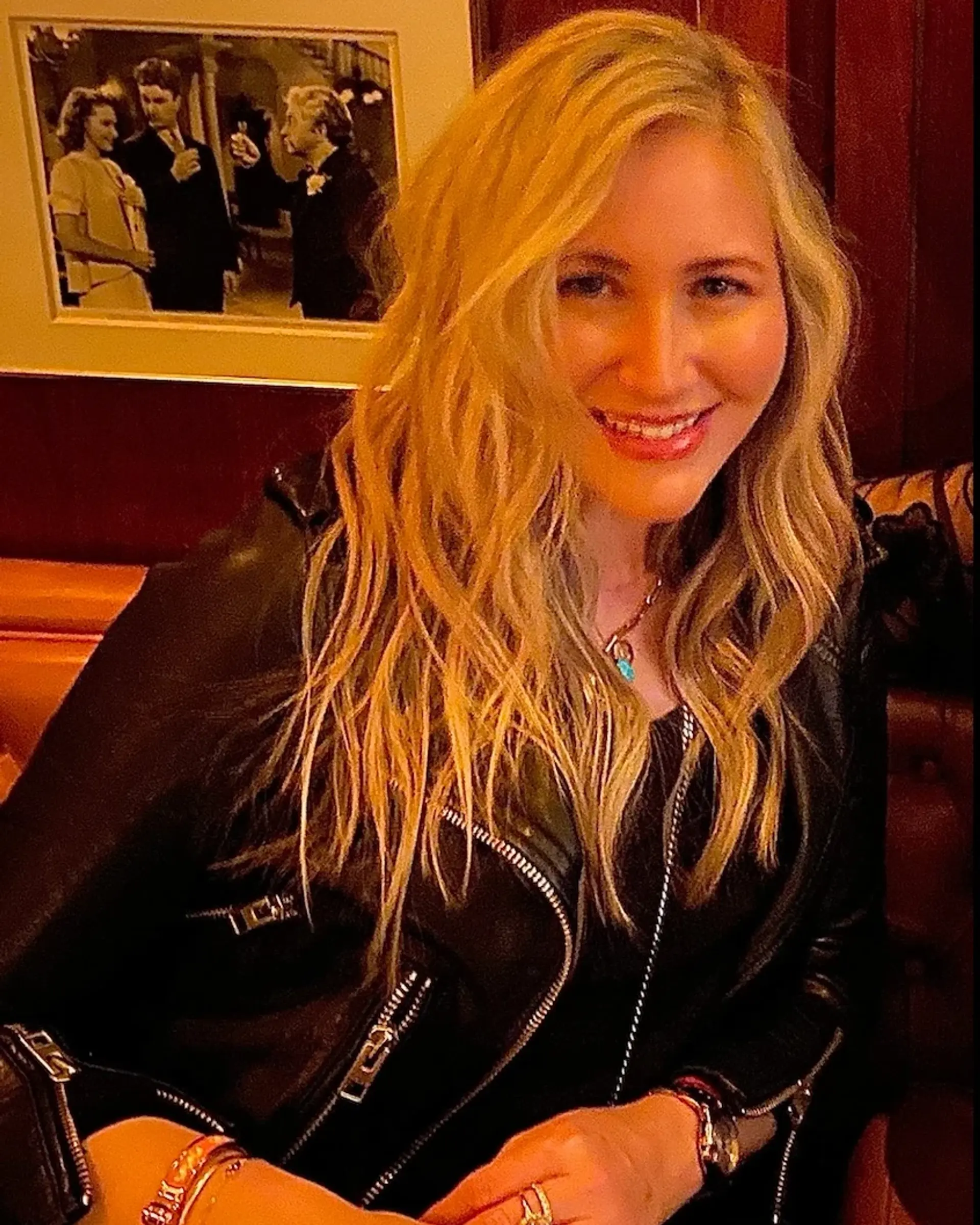 Long multi-tonal blonde hair styled into loose, dimensional waves. 1