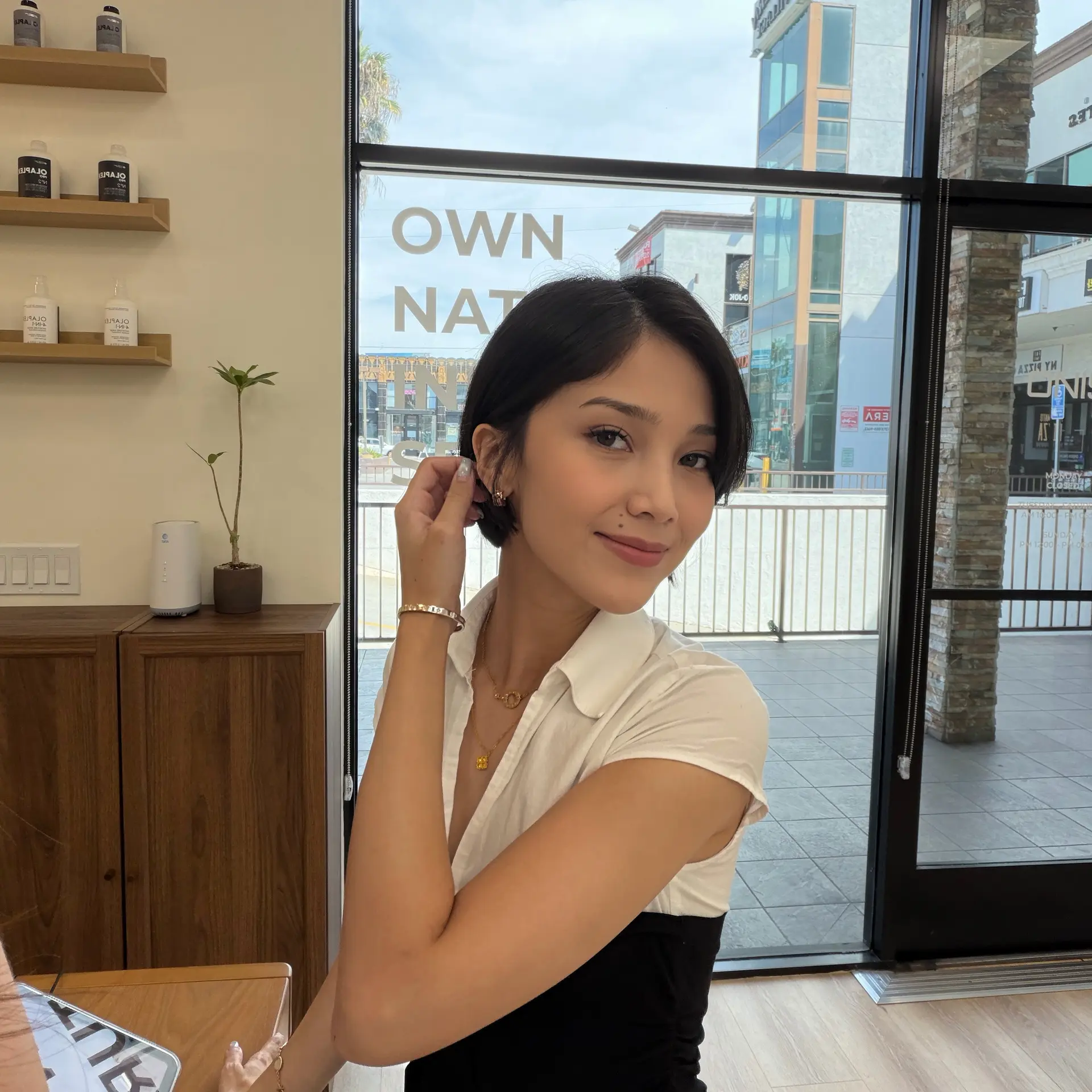 A sleek, classic short bob haircut styled smooth and tucked behind the ear with side-swept bangs. 1