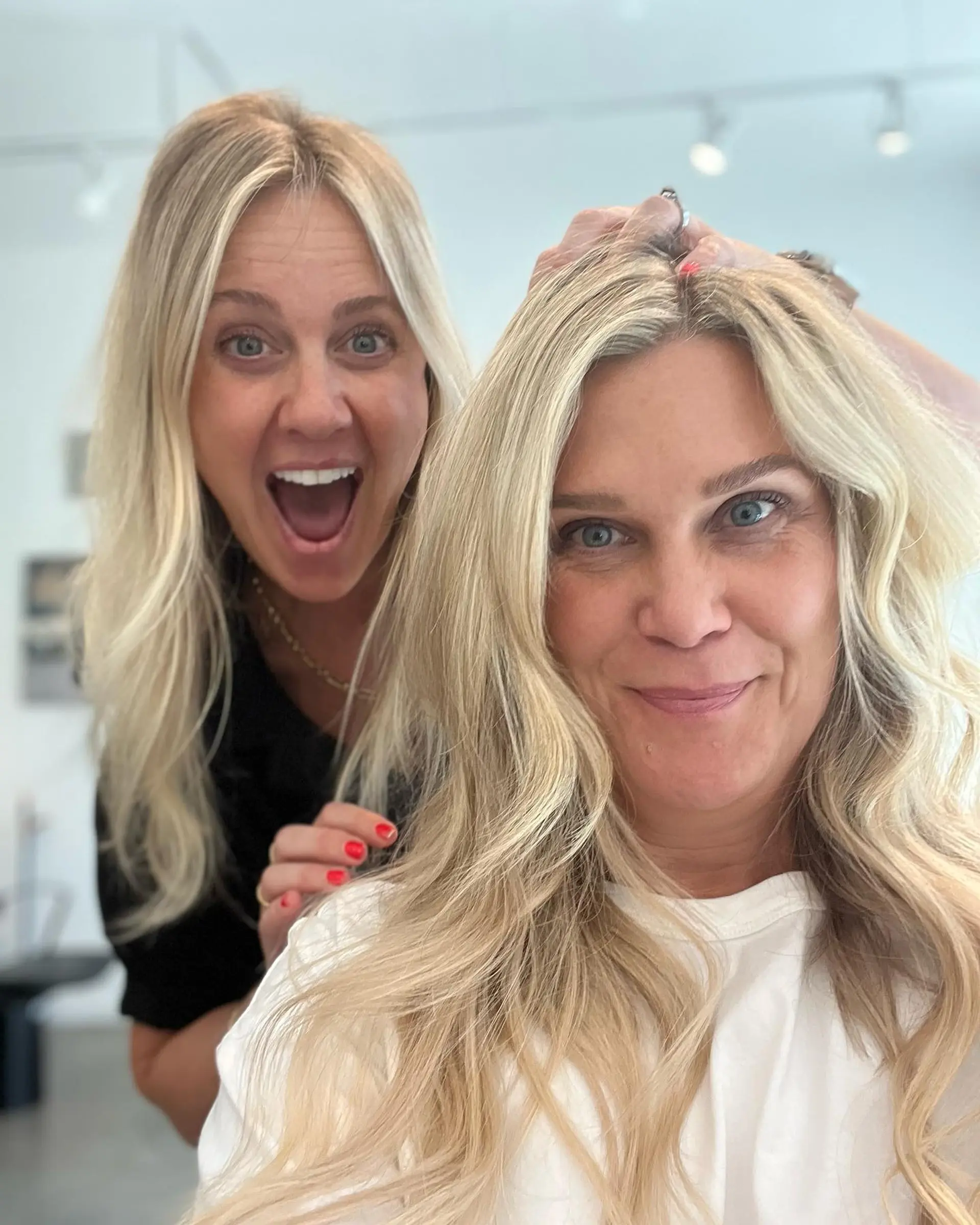 Long, bright blonde hair styled in loose, textured waves with a natural center part. 1
