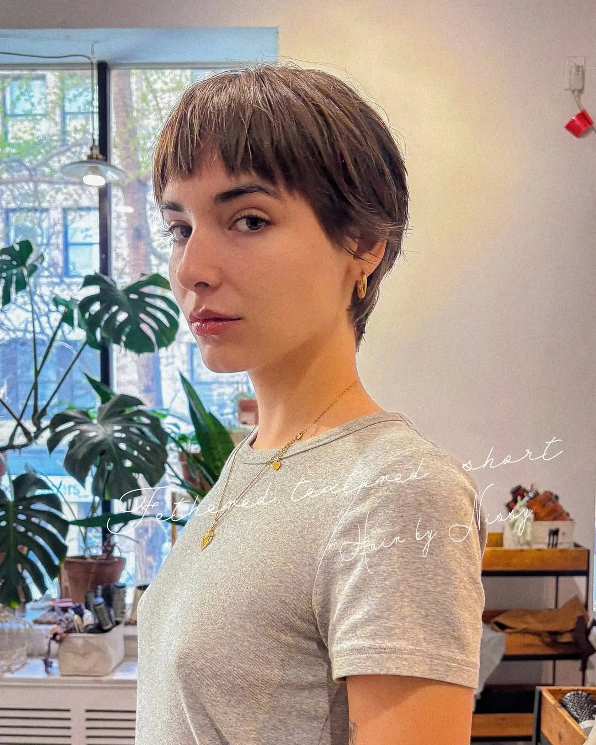 A trendy pixie bob haircut with short bangs and choppy layers for added texture. 1