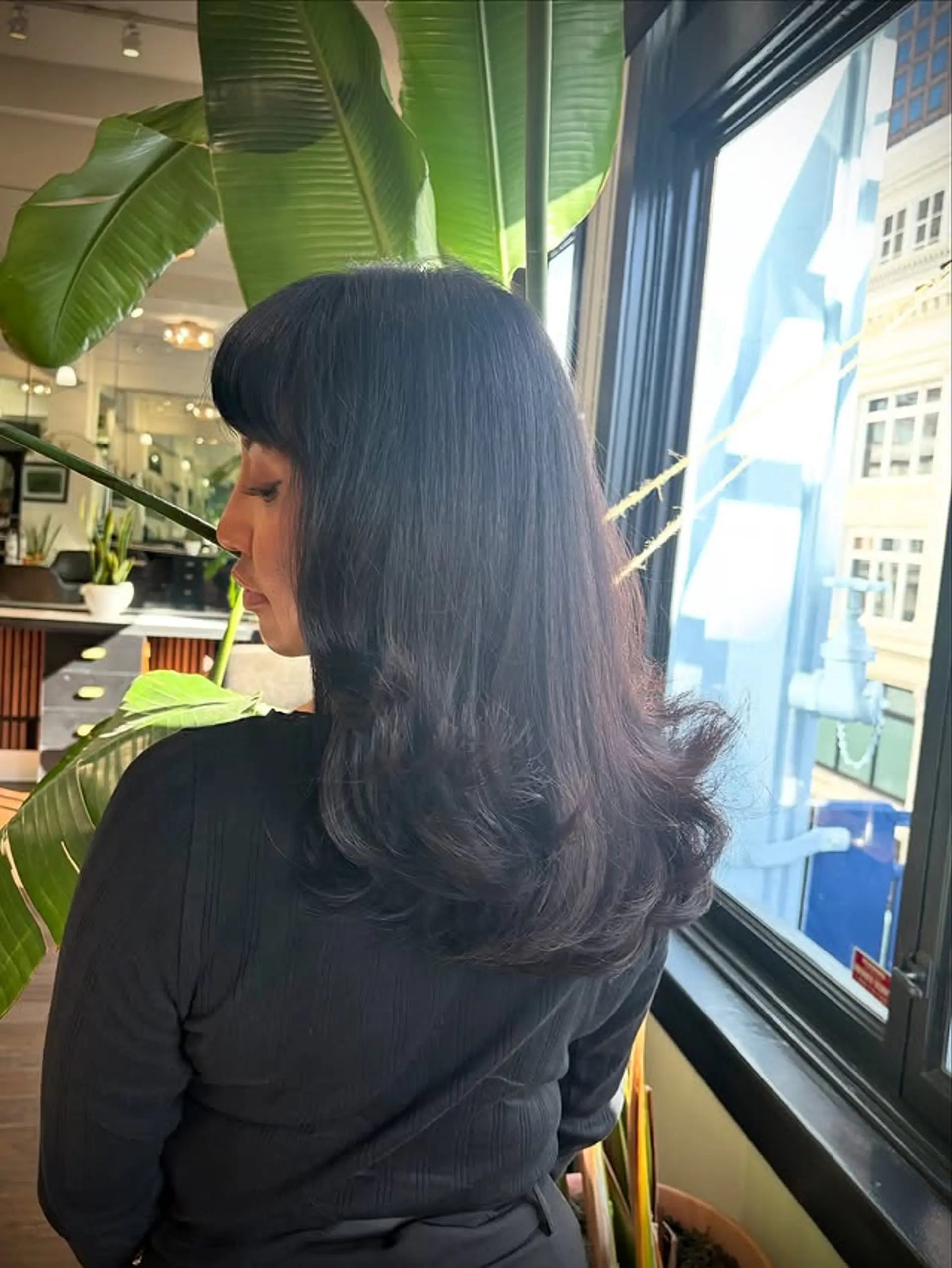 This hairstyle features curtain bangs and layers throughout the hair. 1