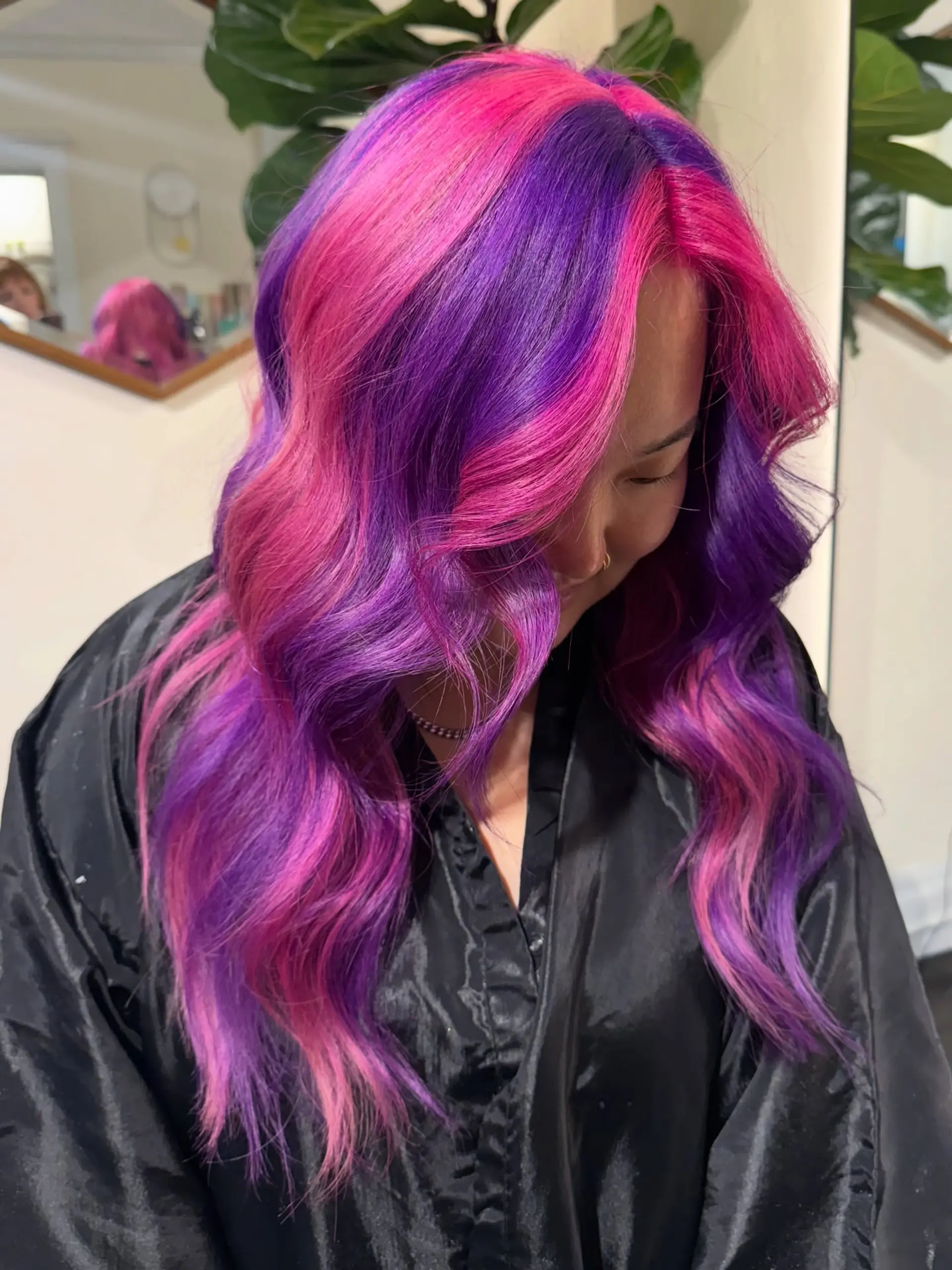 Vibrant alternating blocks of neon hot pink and electric purple styled into loose, voluminous waves. 1