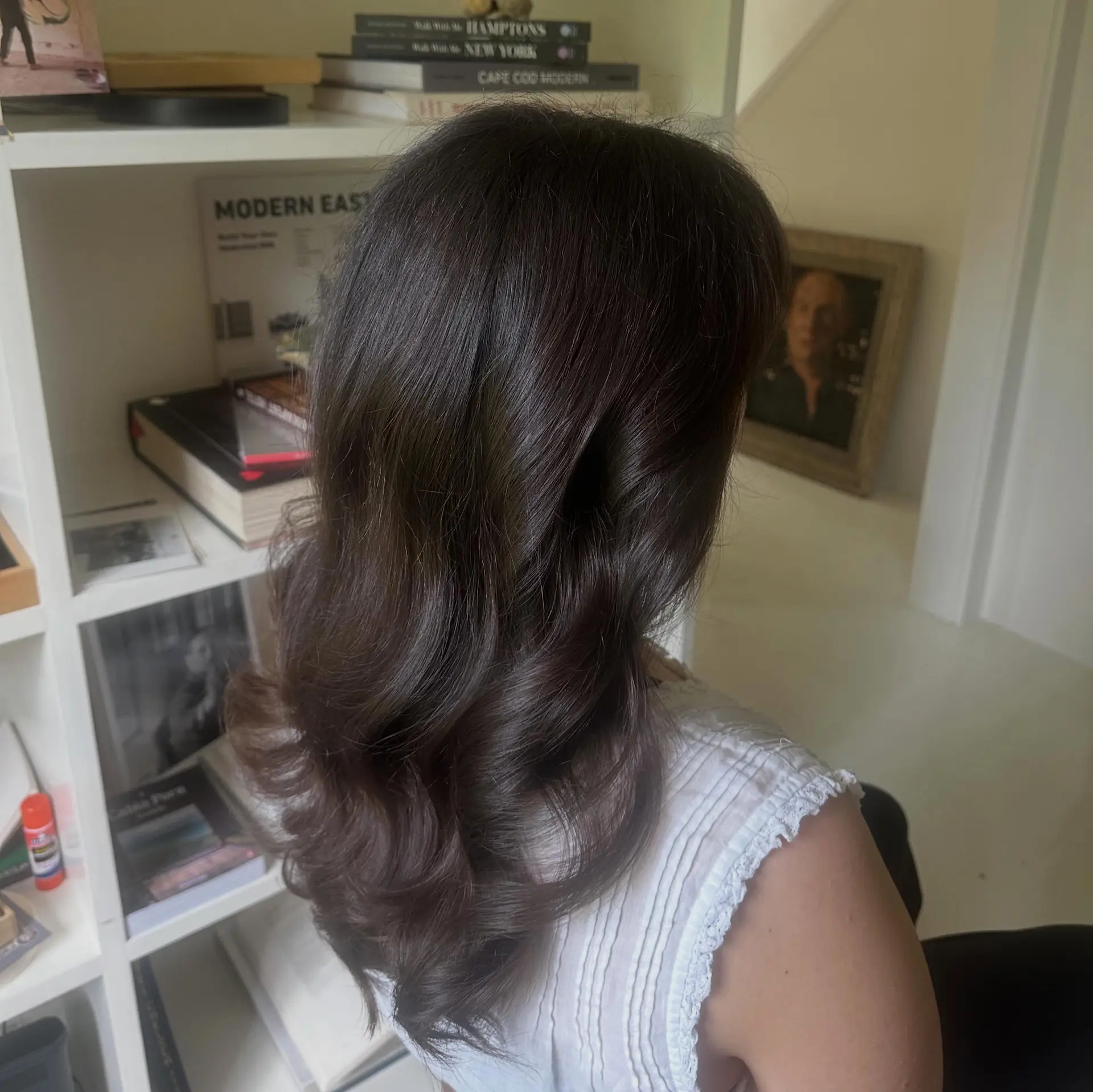 Rich dark brown long hair styled into soft, voluminous, polished waves. 1