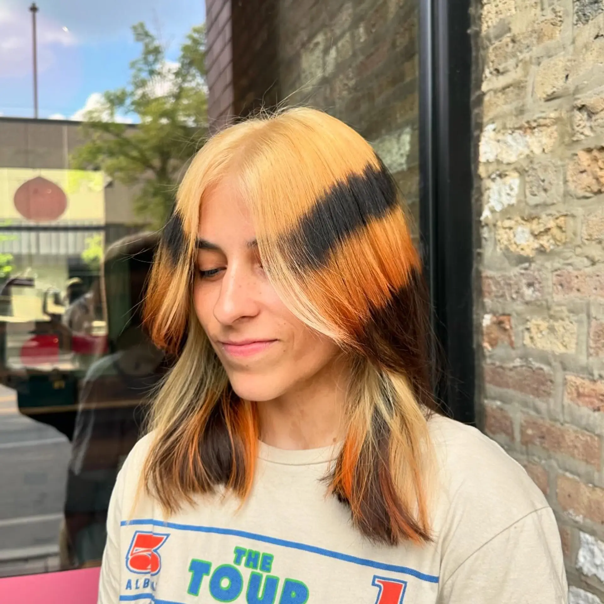 Medium straight hair with bold chunky money piece highlights, featuring contrasting colors. 1