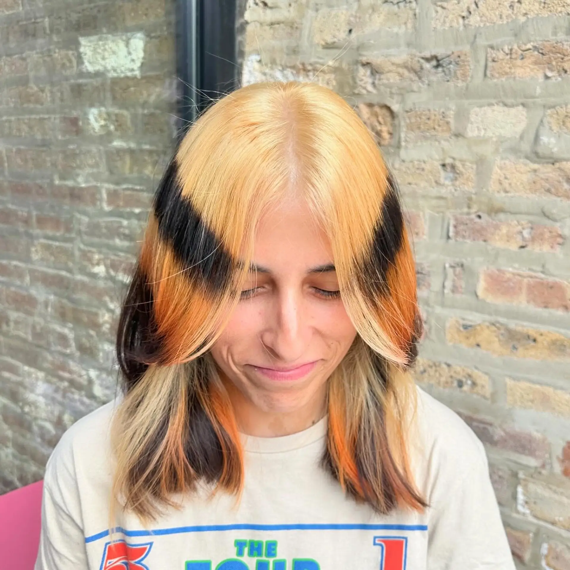 Medium straight hair with bold chunky money piece highlights, featuring contrasting colors. 3