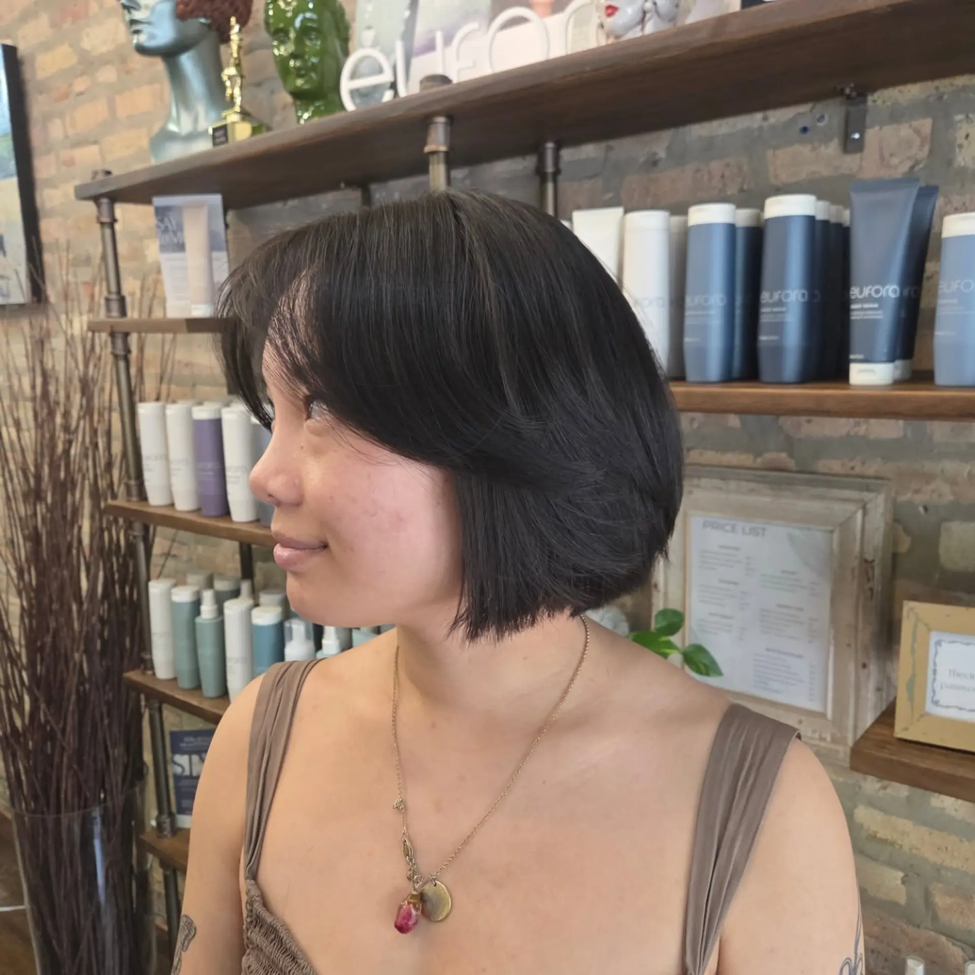 A sleek, chin-length bob paired with soft, cheekbone-skimming curtain bangs. 1
