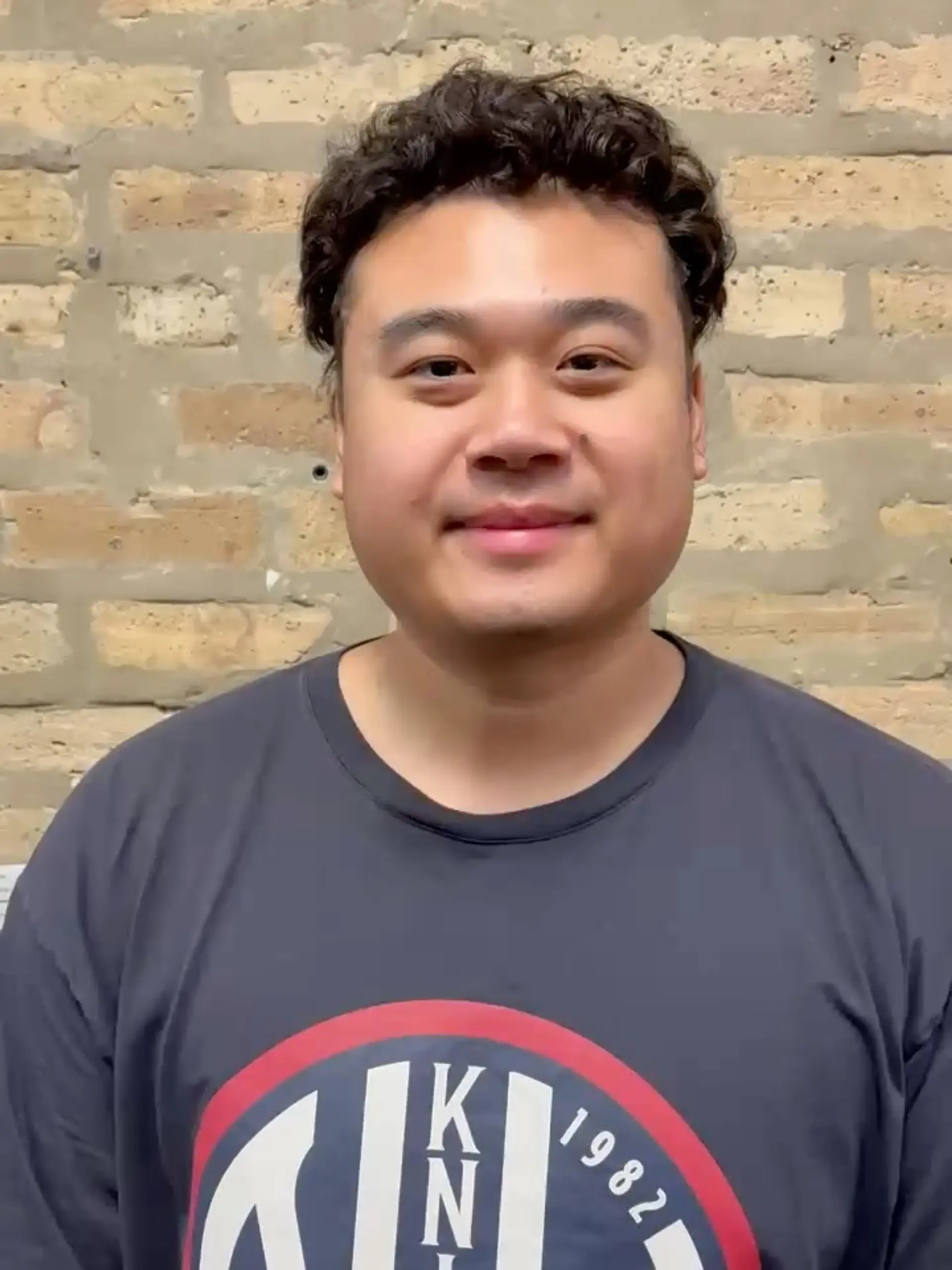 Short haircut styled with soft permed curls and natural texture, lifted off the forehead. 1