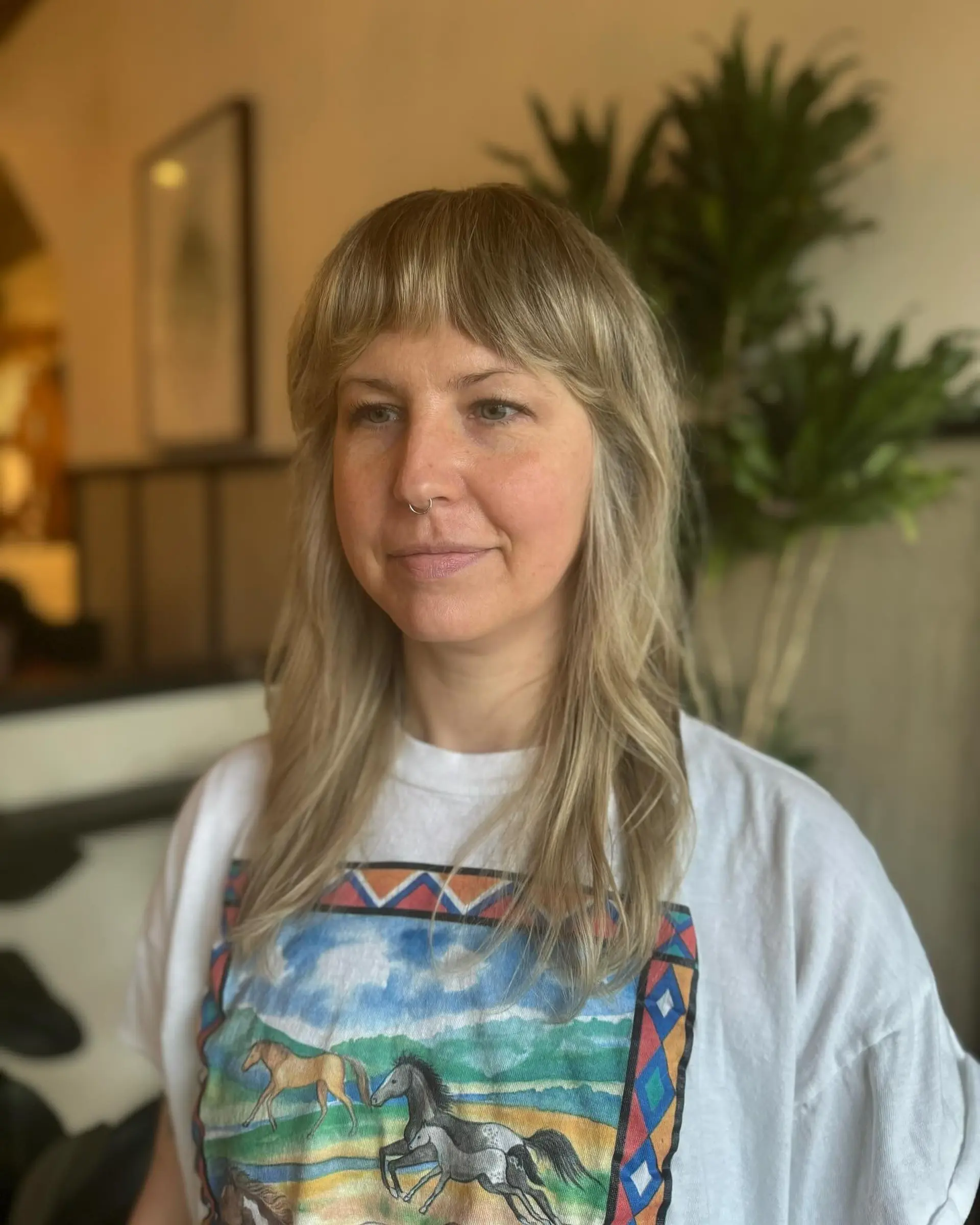 A textured shag haircut with curtain bangs and face-framing layers. 1