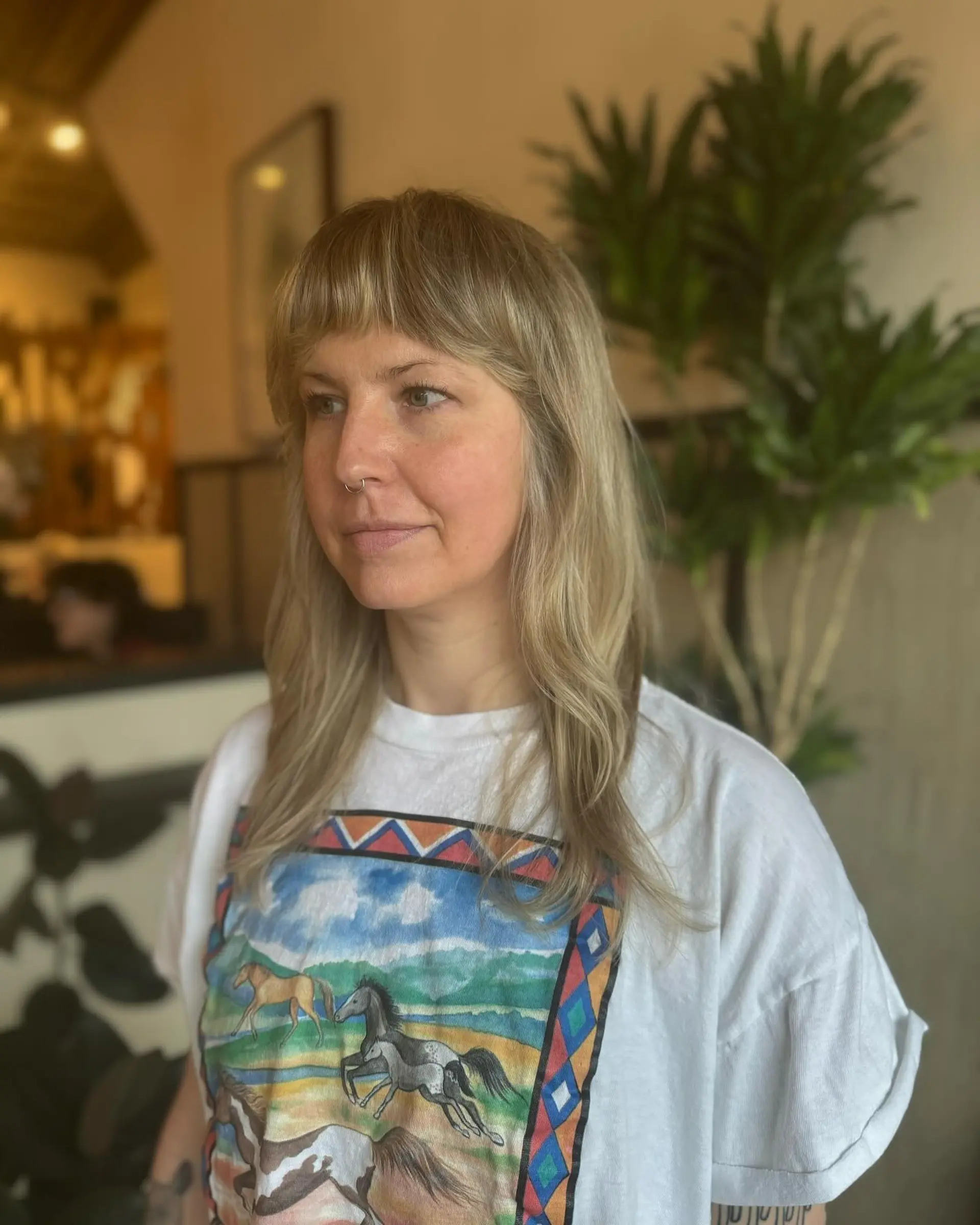 A textured shag haircut with curtain bangs and face-framing layers. 2