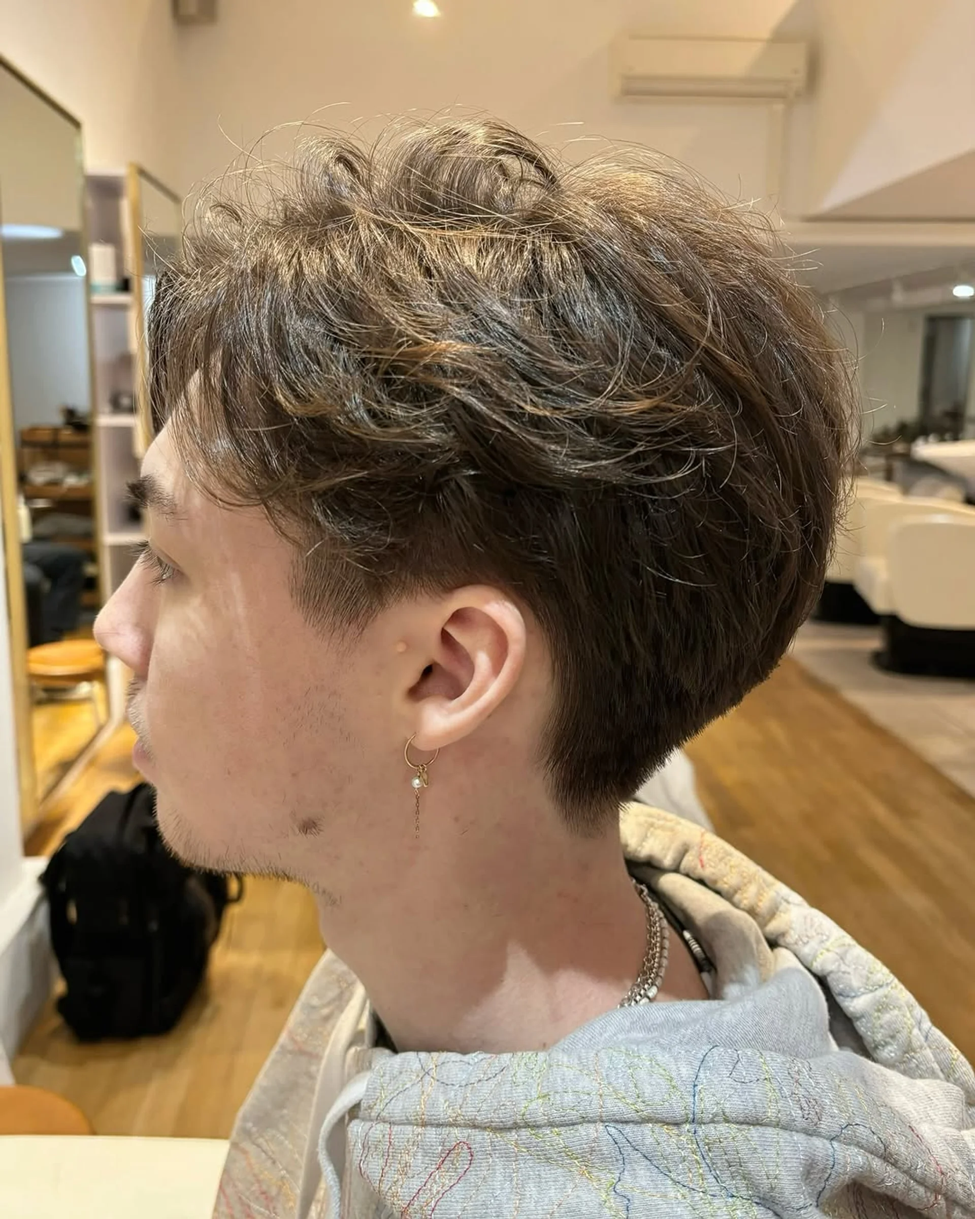 A modern textured crop with a clean fade, showcasing seamless blending in men's hair for 2025. - Preview 1