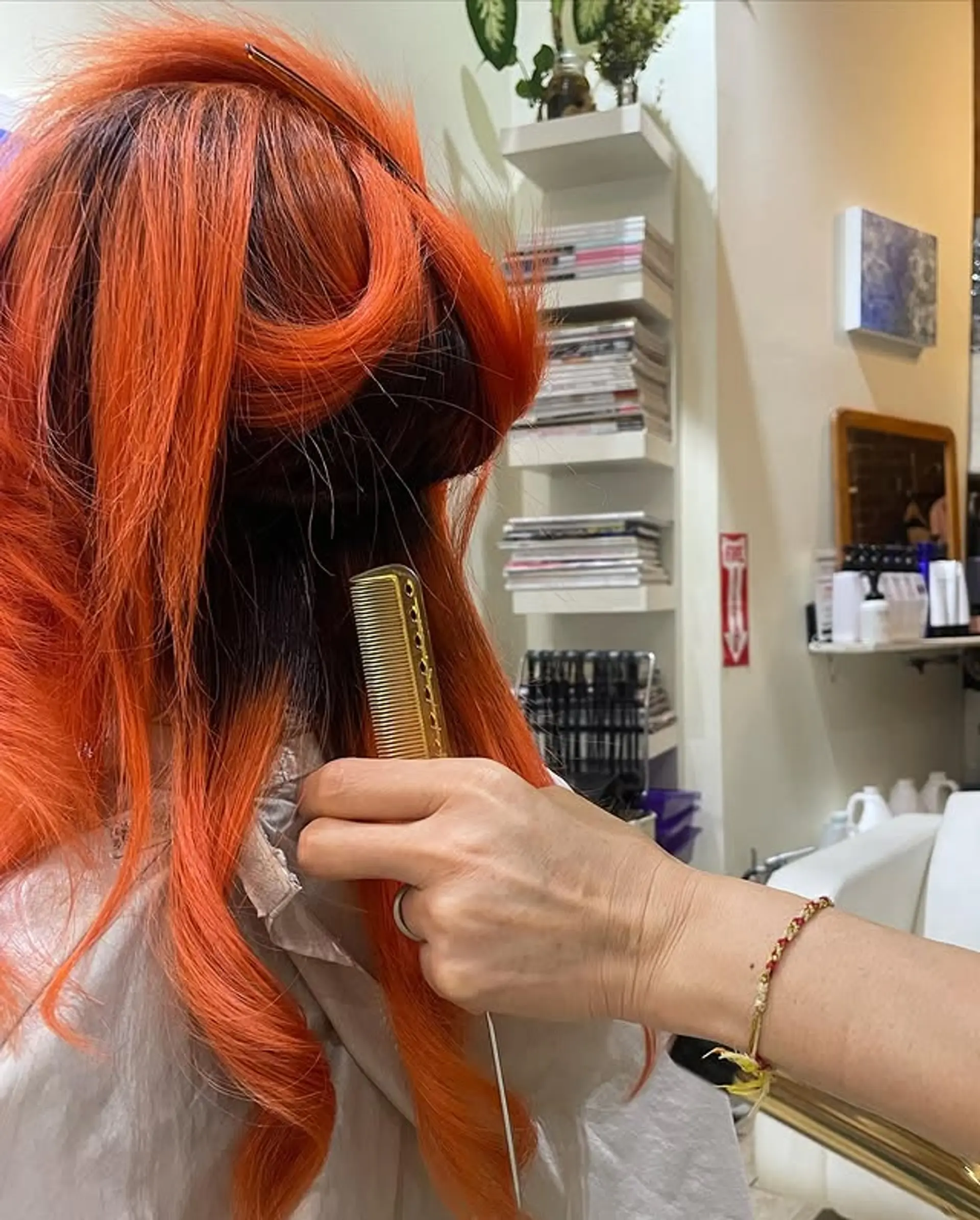 A wavy, medium-length hairstyle with a vibrant copper color and dark roots. 1