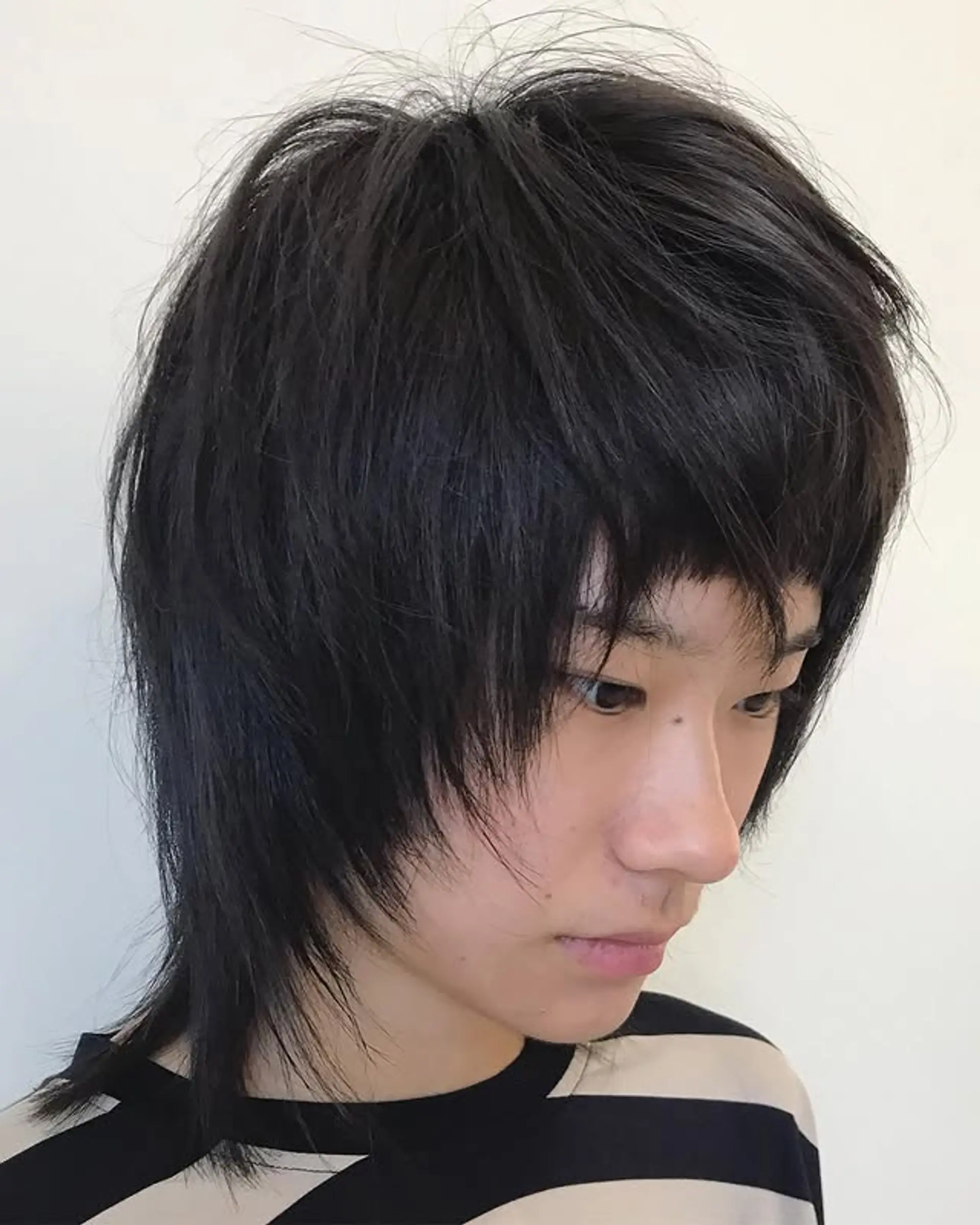 A modern take on the classic mullet with a shaggy texture, choppy layers, and super short baby bangs. 1