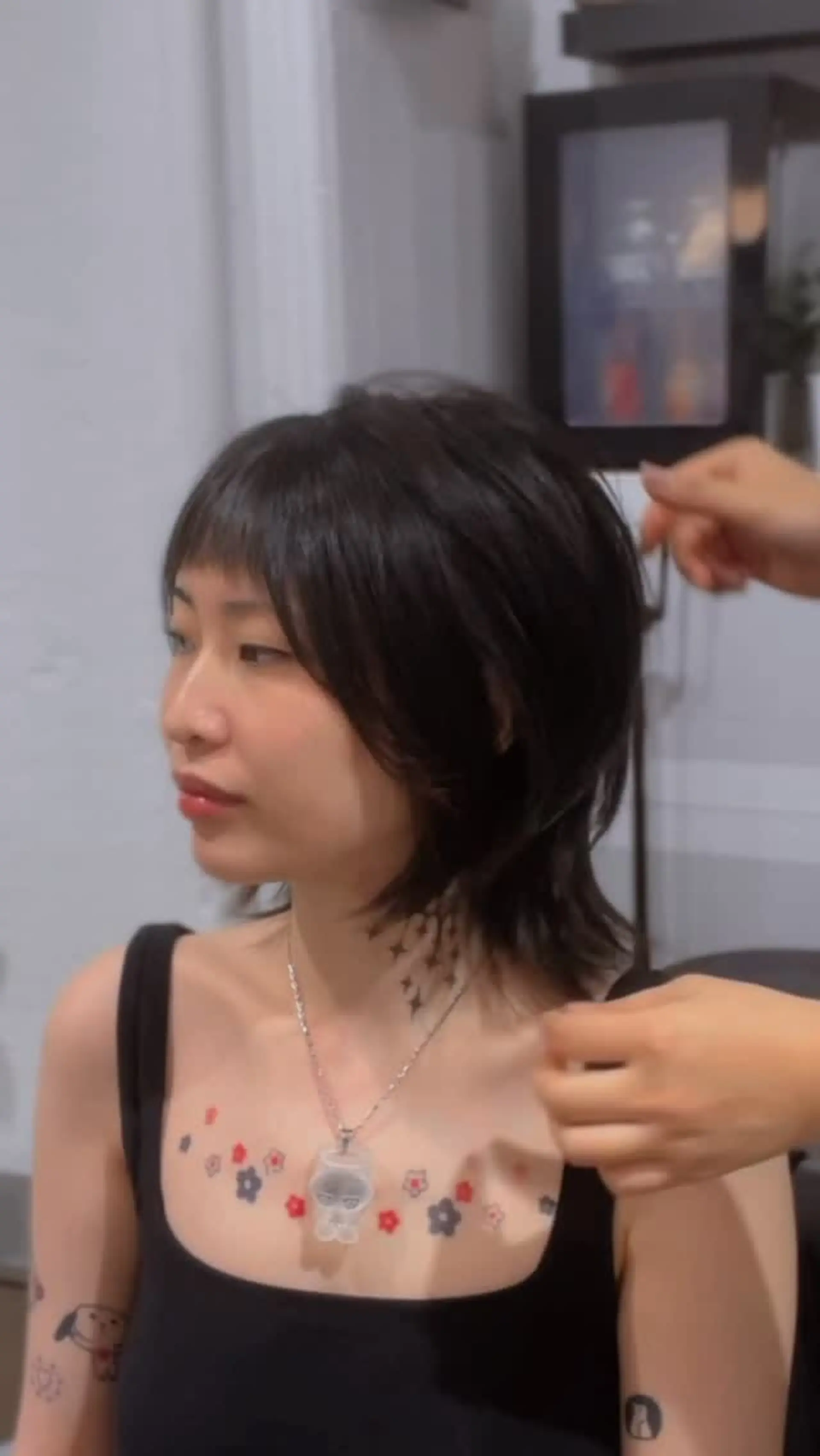 A soft wolf cut and modern mullet featuring wispy micro bangs and textured, feathered layers. 1
