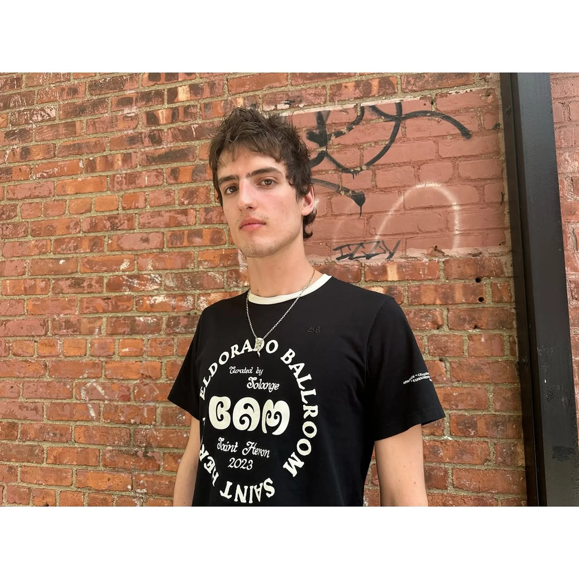 A man with a medium-length textured flow hairstyle with expertly tapered sides, a key trend for 2025. - Preview 3