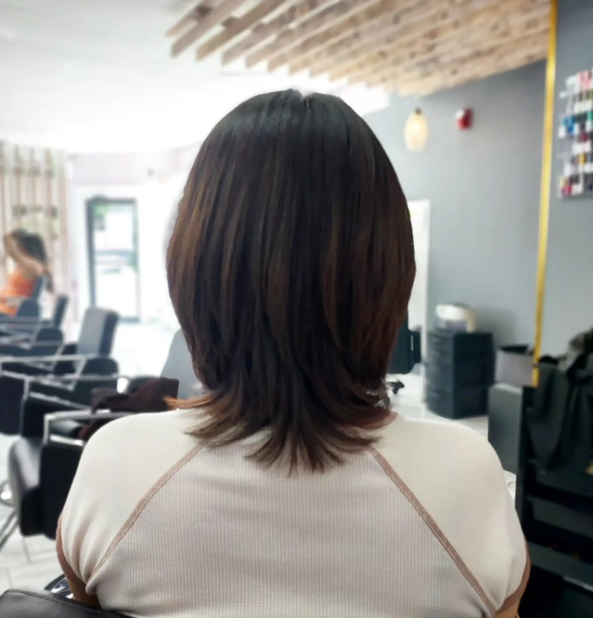 A medium-length layered cut featuring textured, feathered layers with gently flared ends. 1