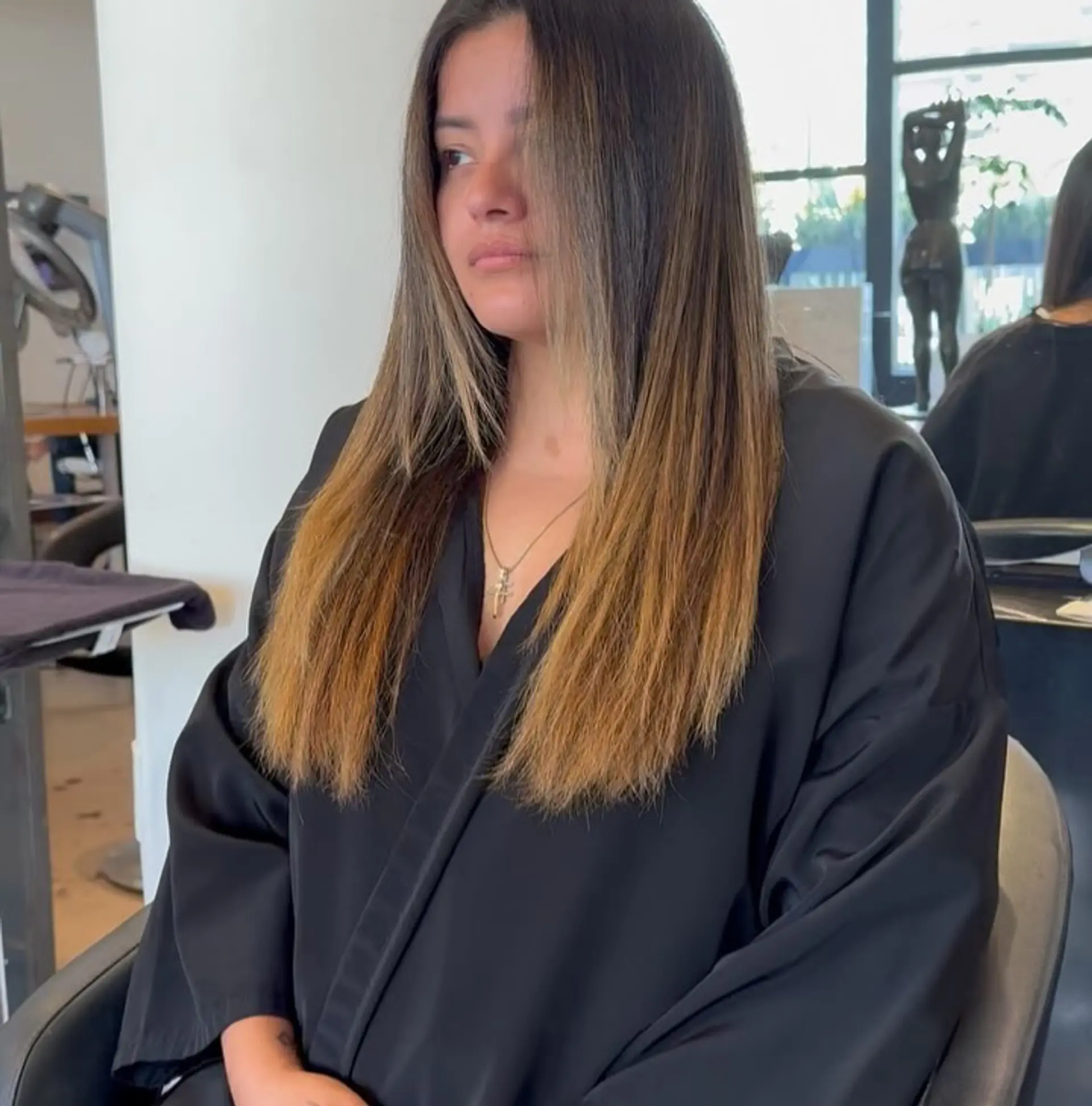 Long straight hair with a seamless golden caramel balayage transition from dark brown roots down to warm honey ends, parted down the center. 1