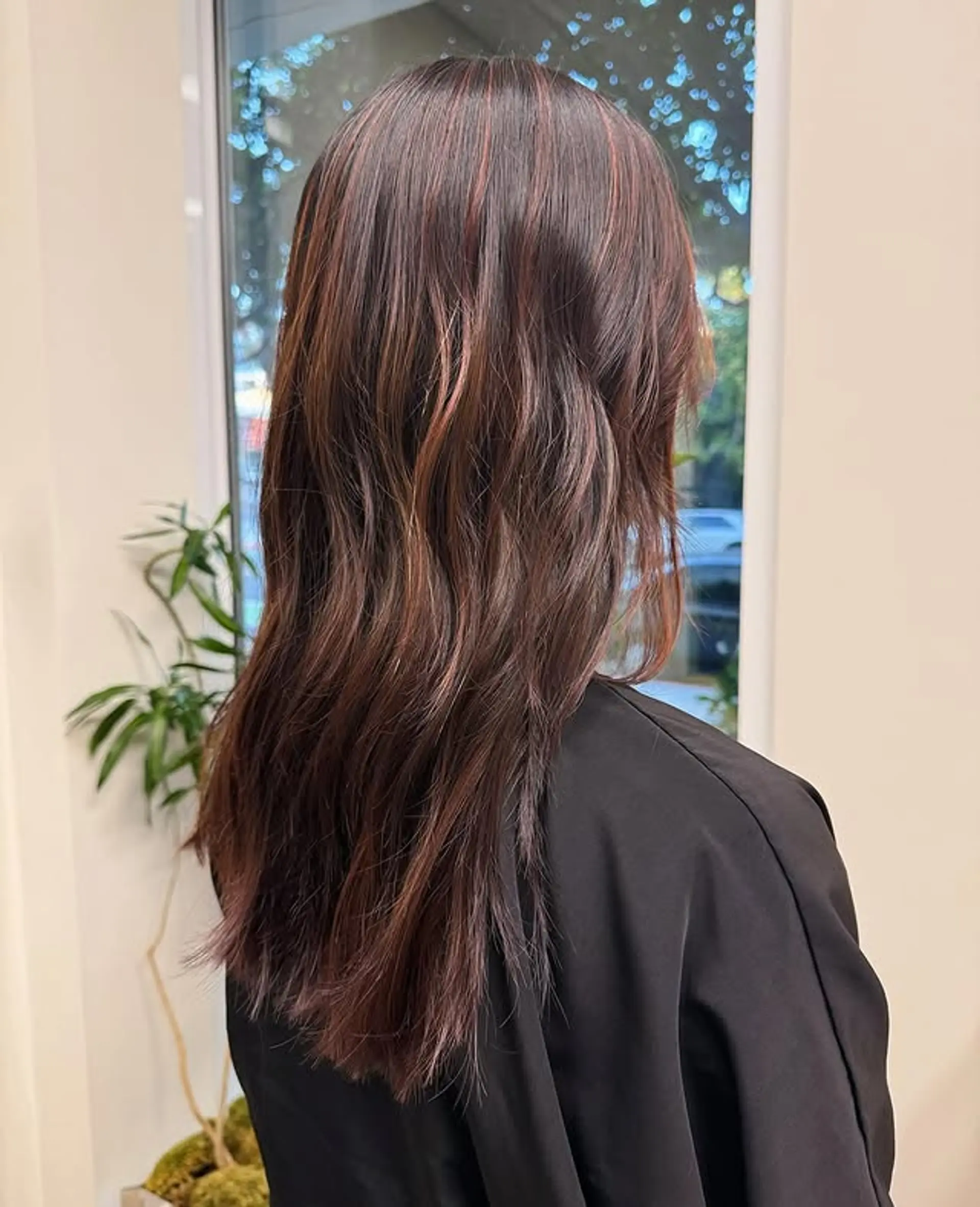 Long, layered hair with balayage highlights and a wavy texture. 1