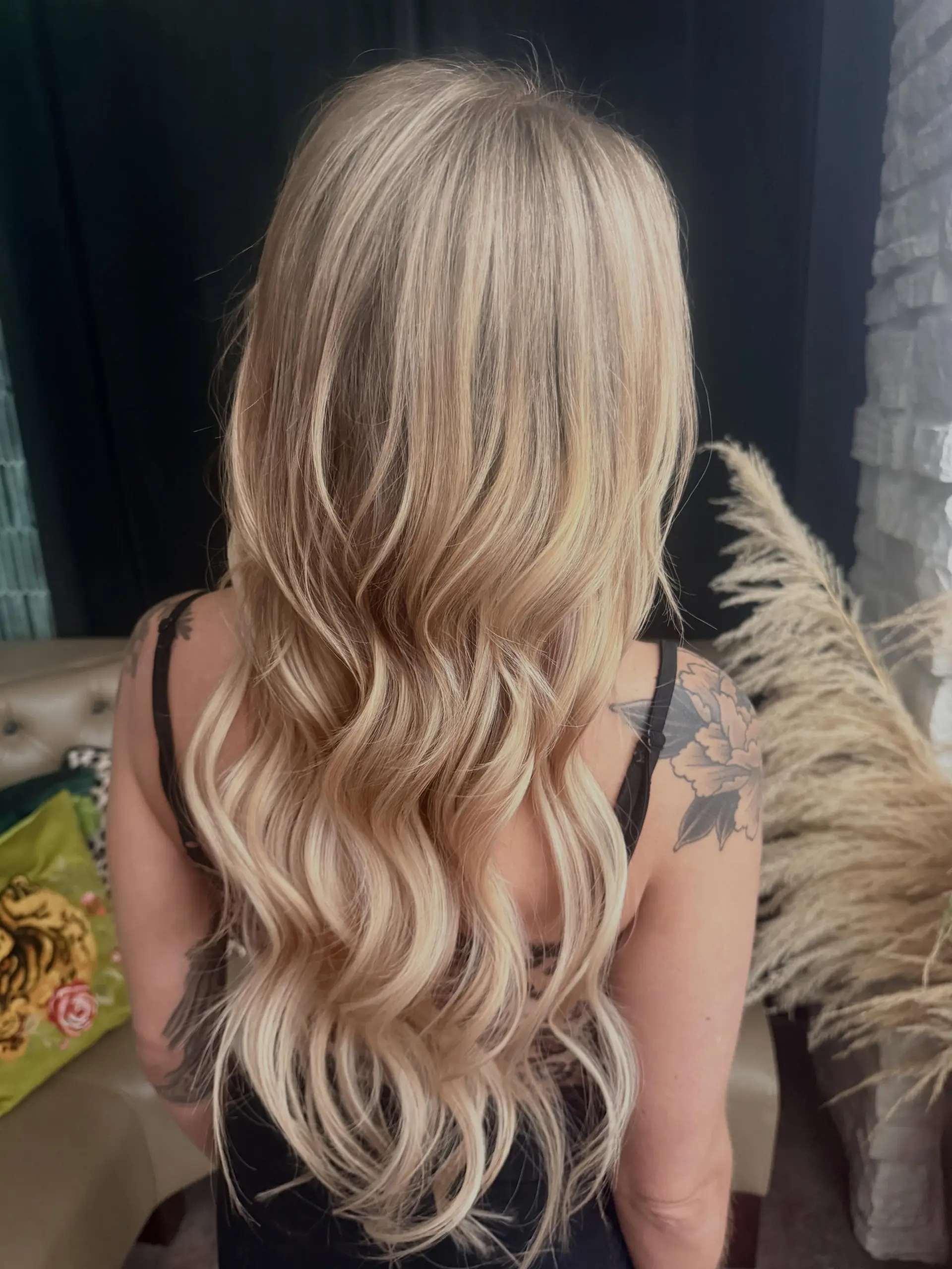 Long, dimensional warm blonde hair styled in soft cascading waves. 1