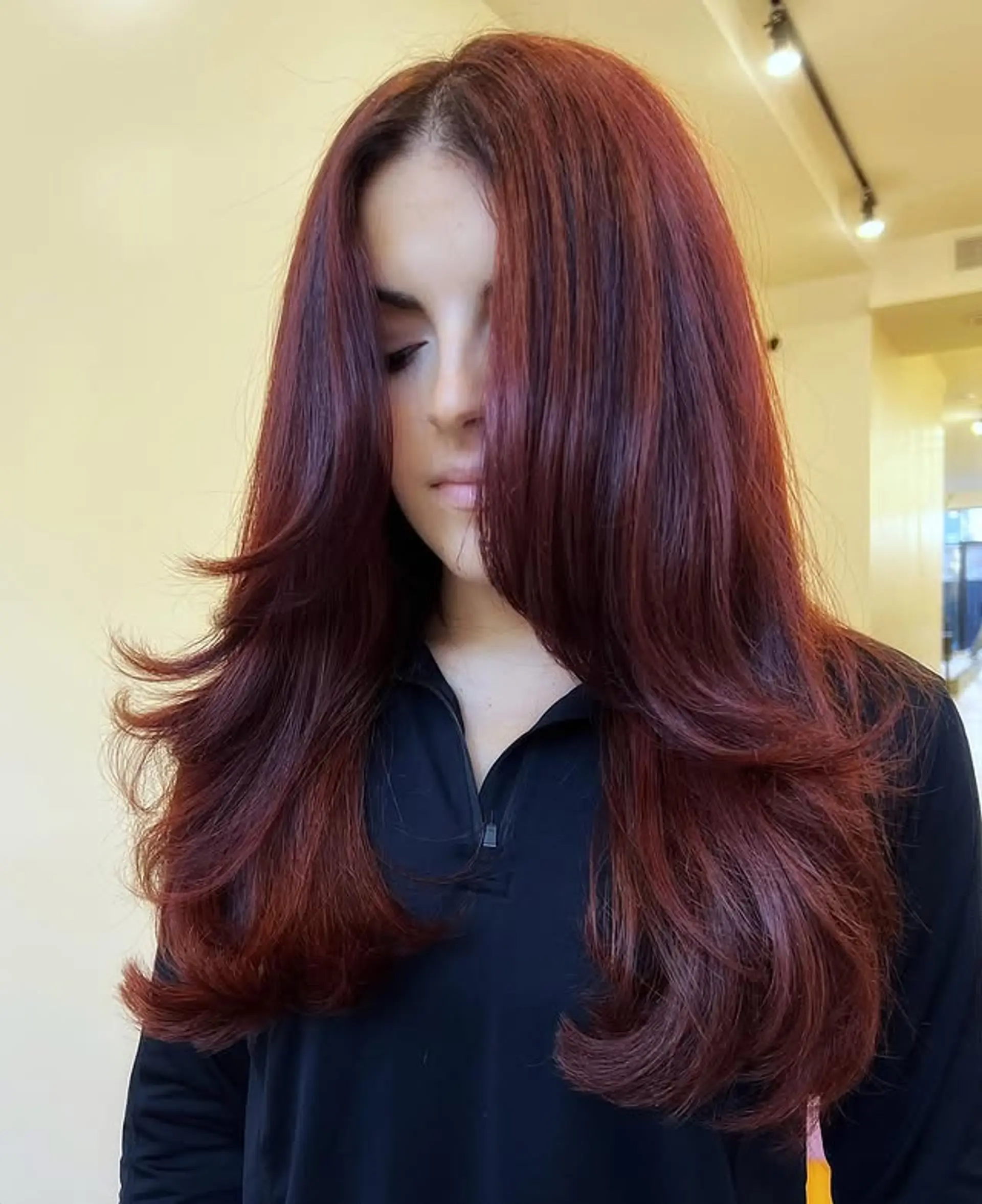 Long layered hairstyle with face-framing layers for added movement. 1