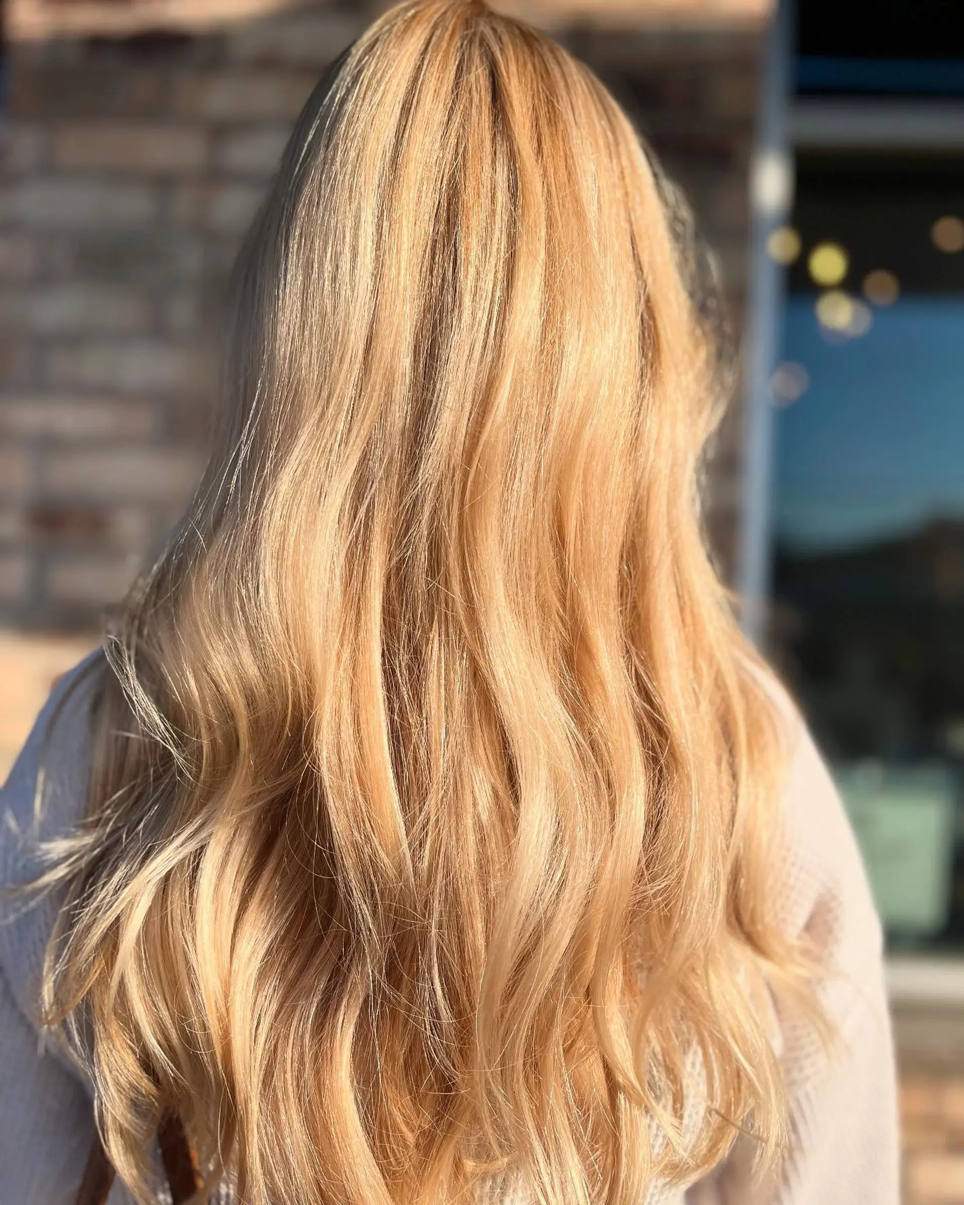 Long, luminous warm golden blonde hair styled in soft, natural textured waves. 1