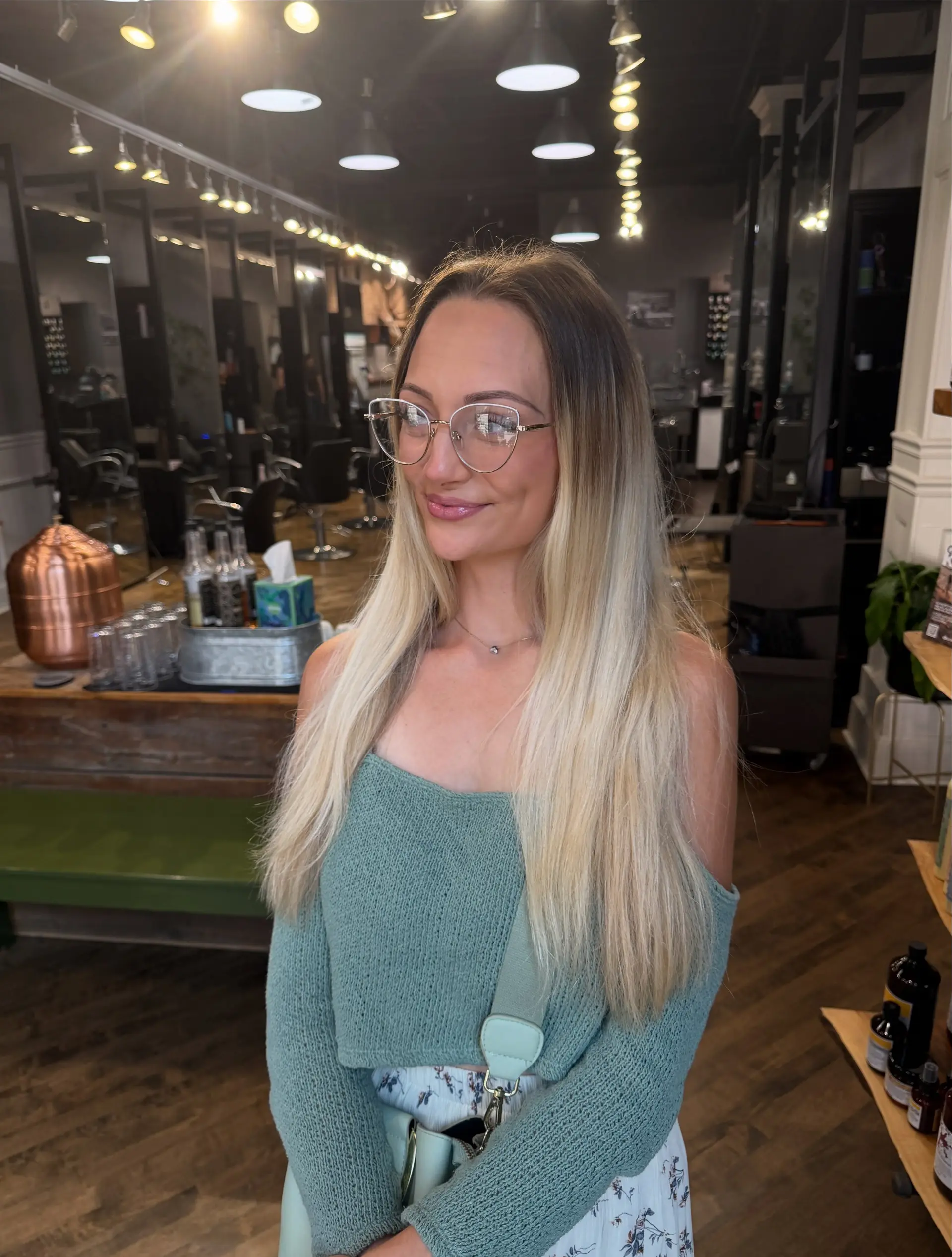Straight, long dimensional blonde hair with a soft shadow root melt. 1