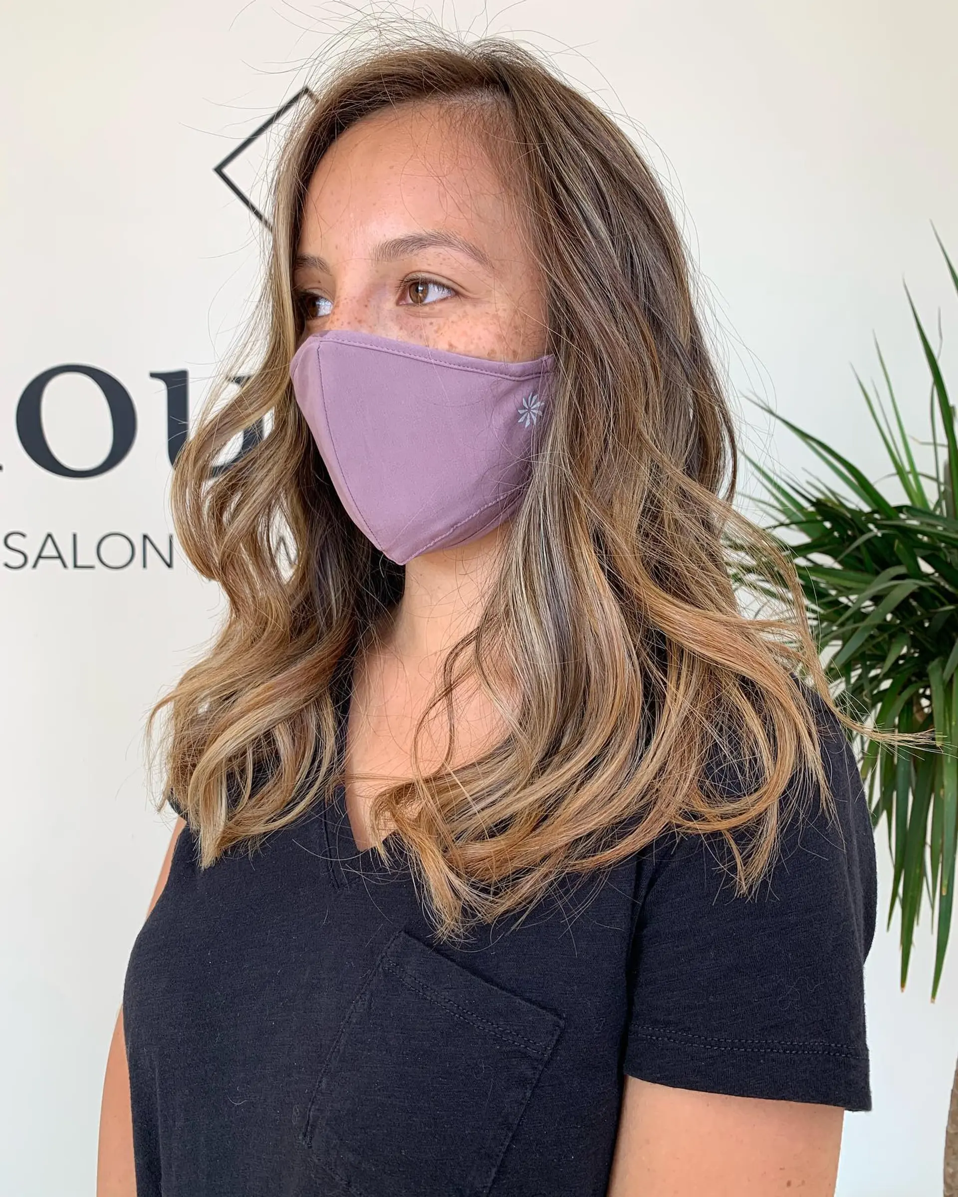 Long layered hair featuring seamless warm blonde highlights styled into soft, beachy waves. 1