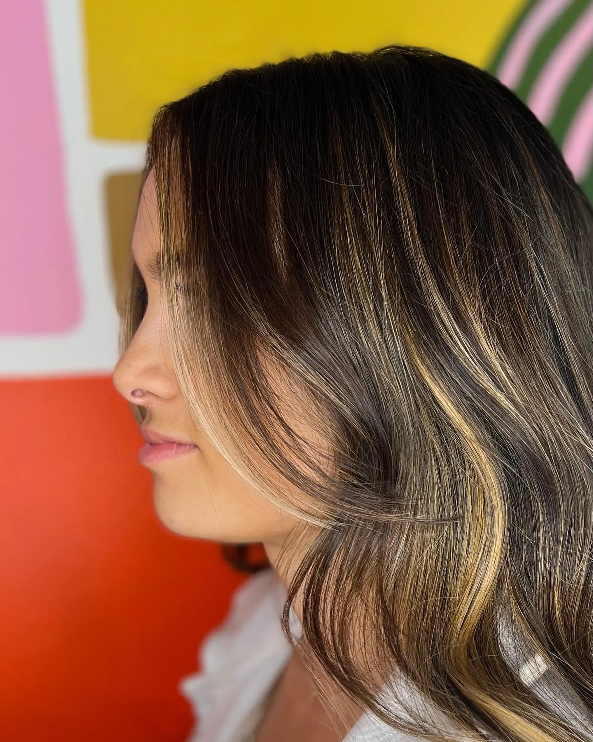 Medium-length dark brown hair featuring fine caramel balayage highlights with soft face-framing layers. 1