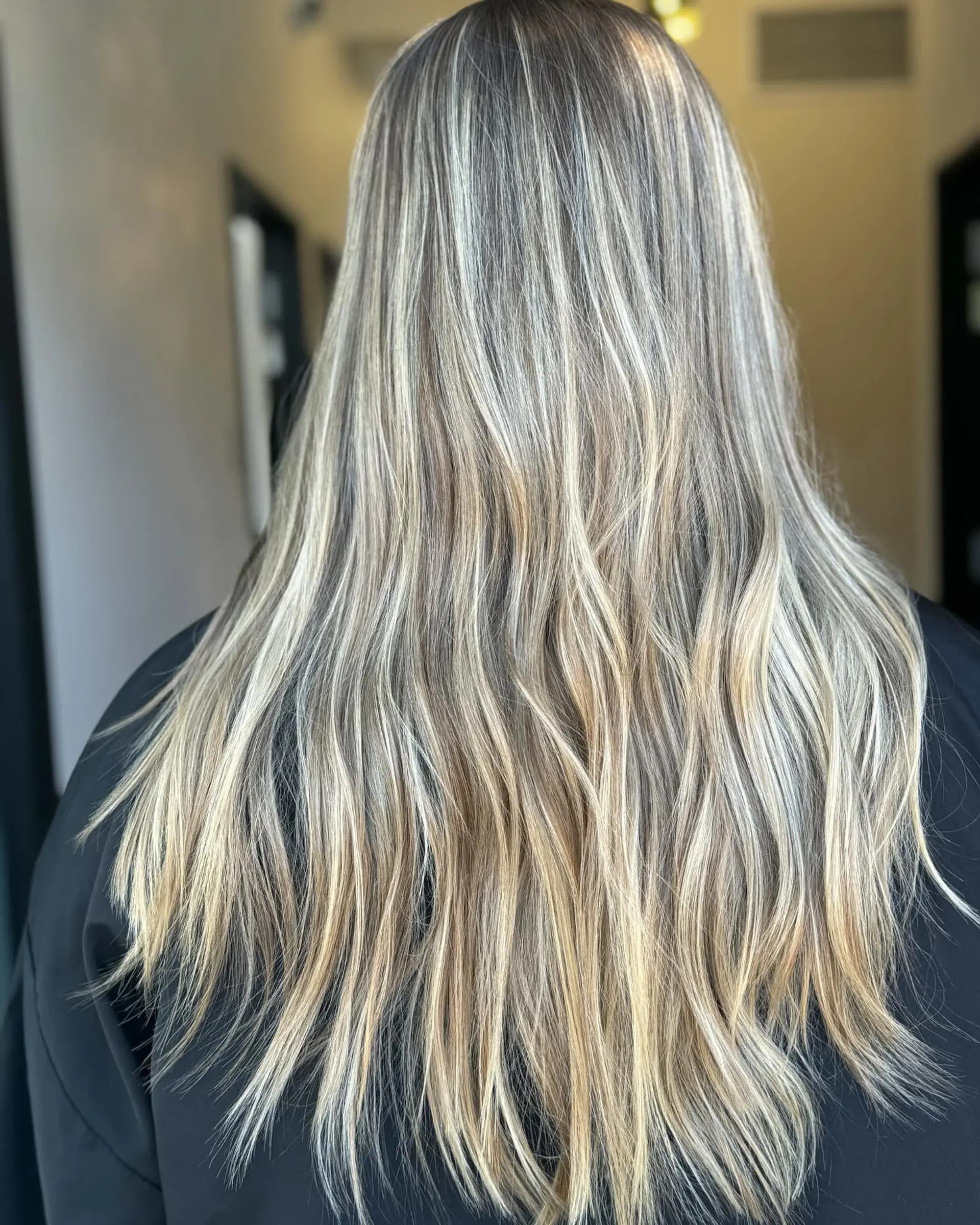 Long hair featuring a seamless dimensional blend of ash and beige blonde highlights over a neutral brunette base. 1