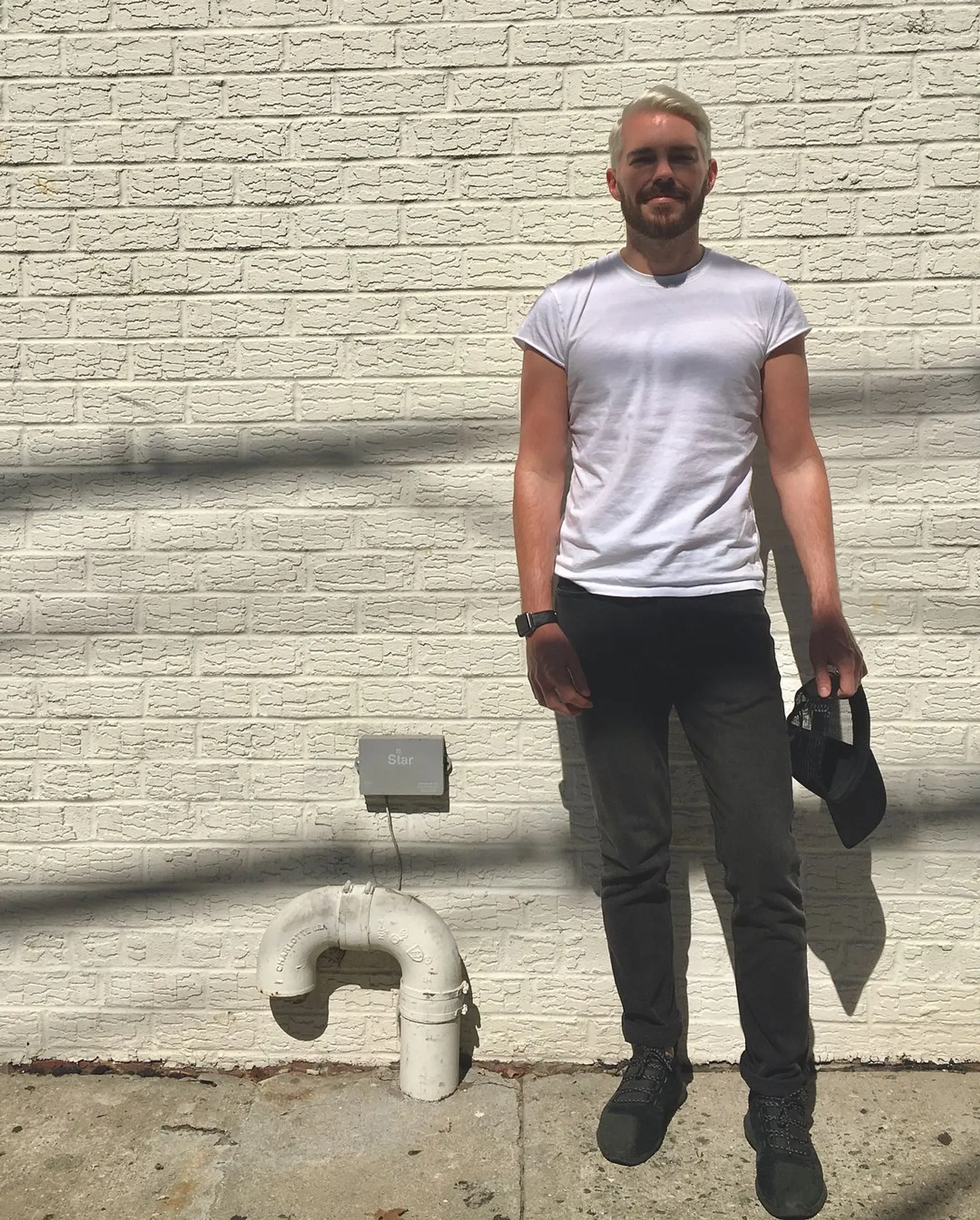 The style features a neat, side-swept quiff in bold platinum blonde, with tapered sides and a textured top for a clean, contemporary look. 2