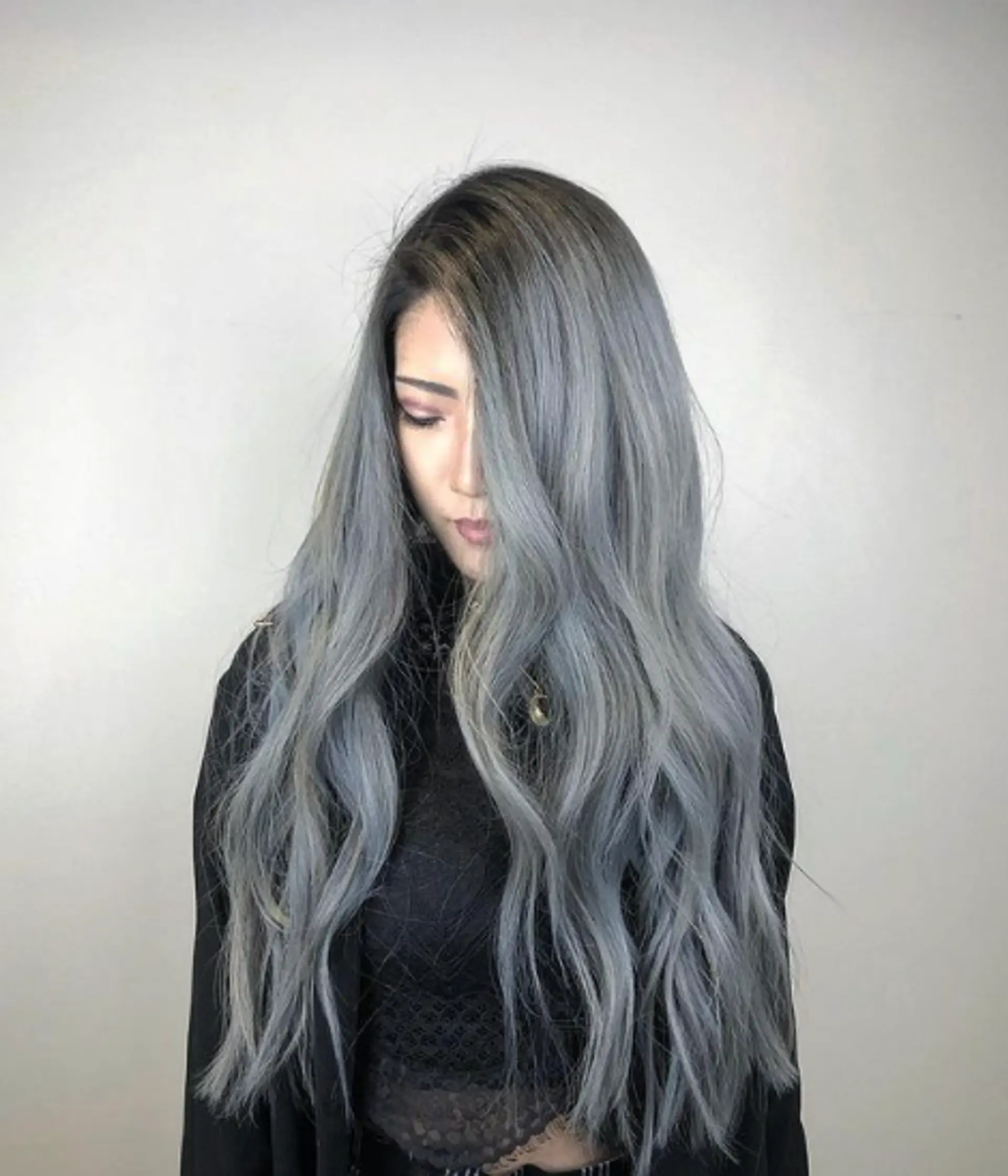 Long, wavy silver hair with a center part and soft, voluminous waves framing the face. 1