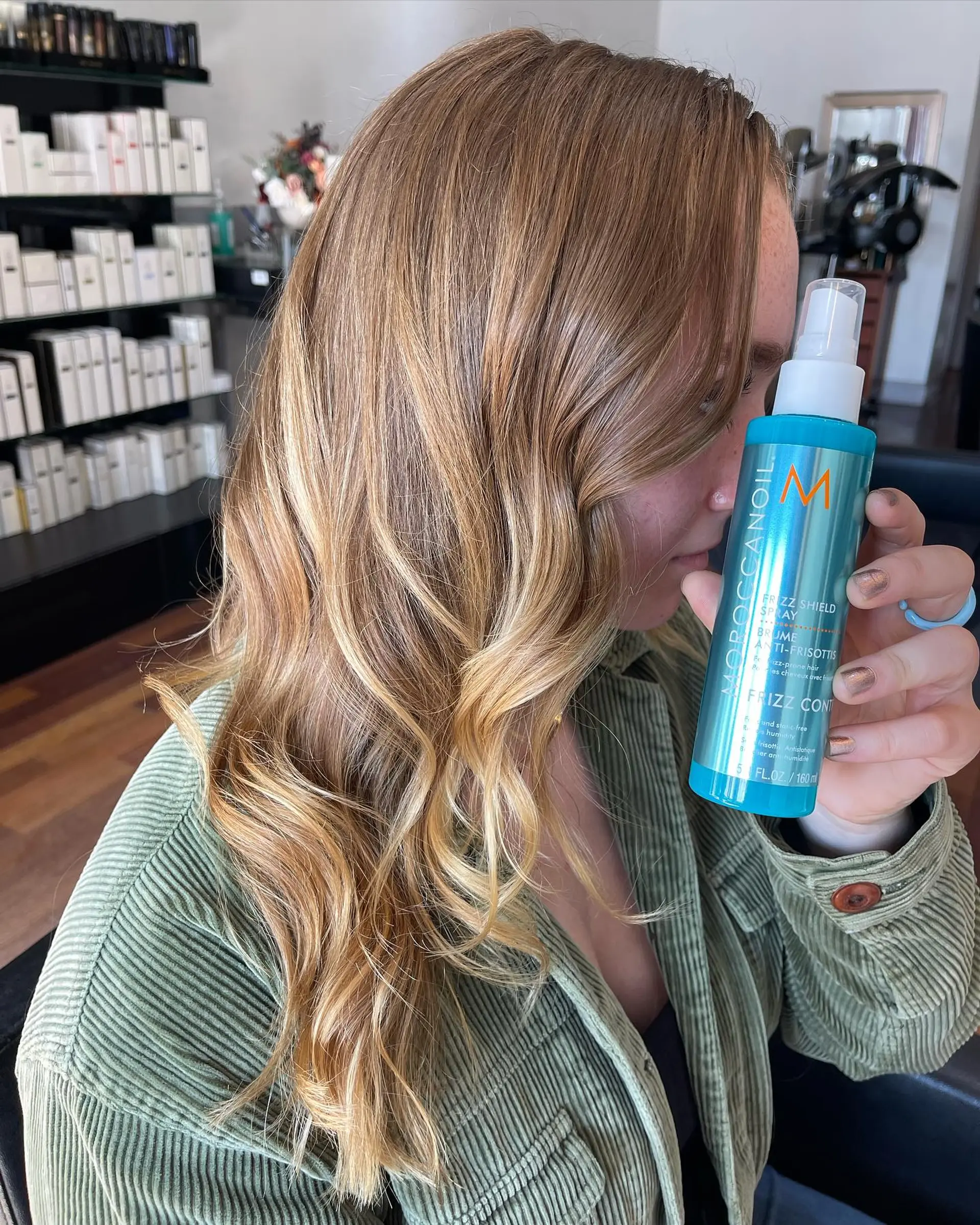 Side angle of long, glossy golden blonde hair styled into loose, smooth waves. 1