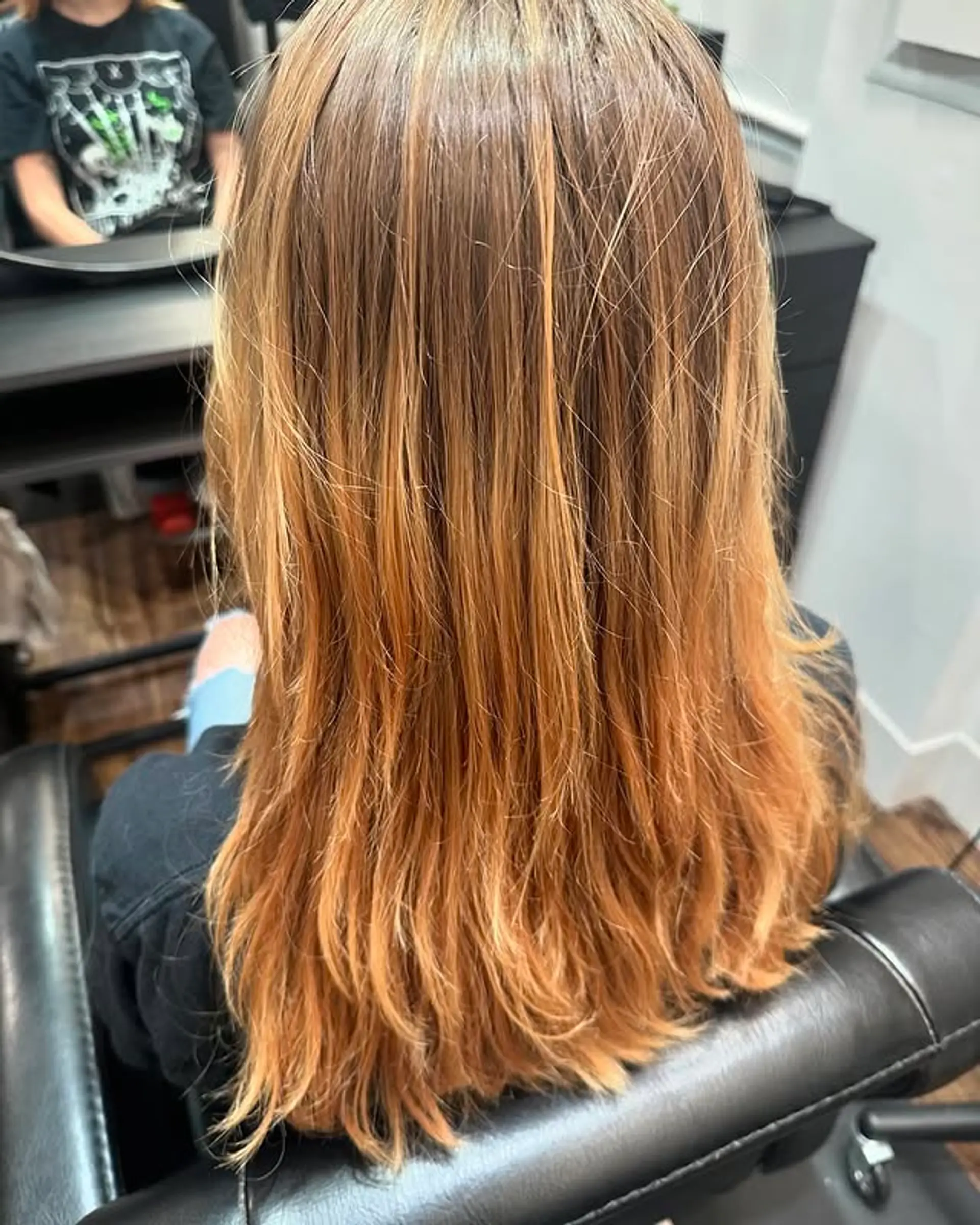 A medium-length layered hairstyle with a copper ombre. 1