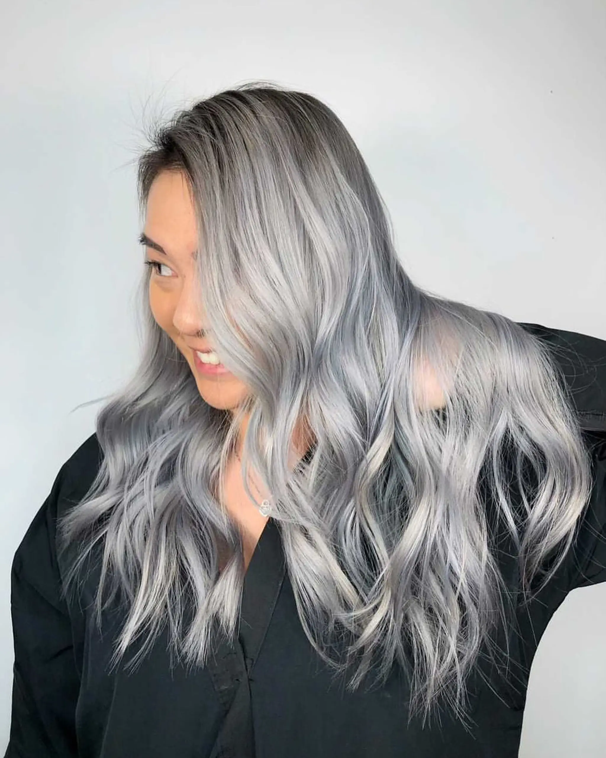 The hairstyle features long, wavy hair in a silver-gray color, with a side part and voluminous, textured waves.
Stylist - @xcellent_jason
